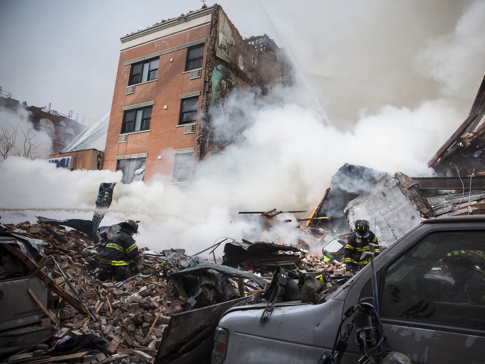 Heavy smoke pours from the debris as the Fire Department of New York (FDNY) responds to a 5-alarm fire and building collapse at 1646 Park Ave in the Harlem neighborhood of Manhattan in New York