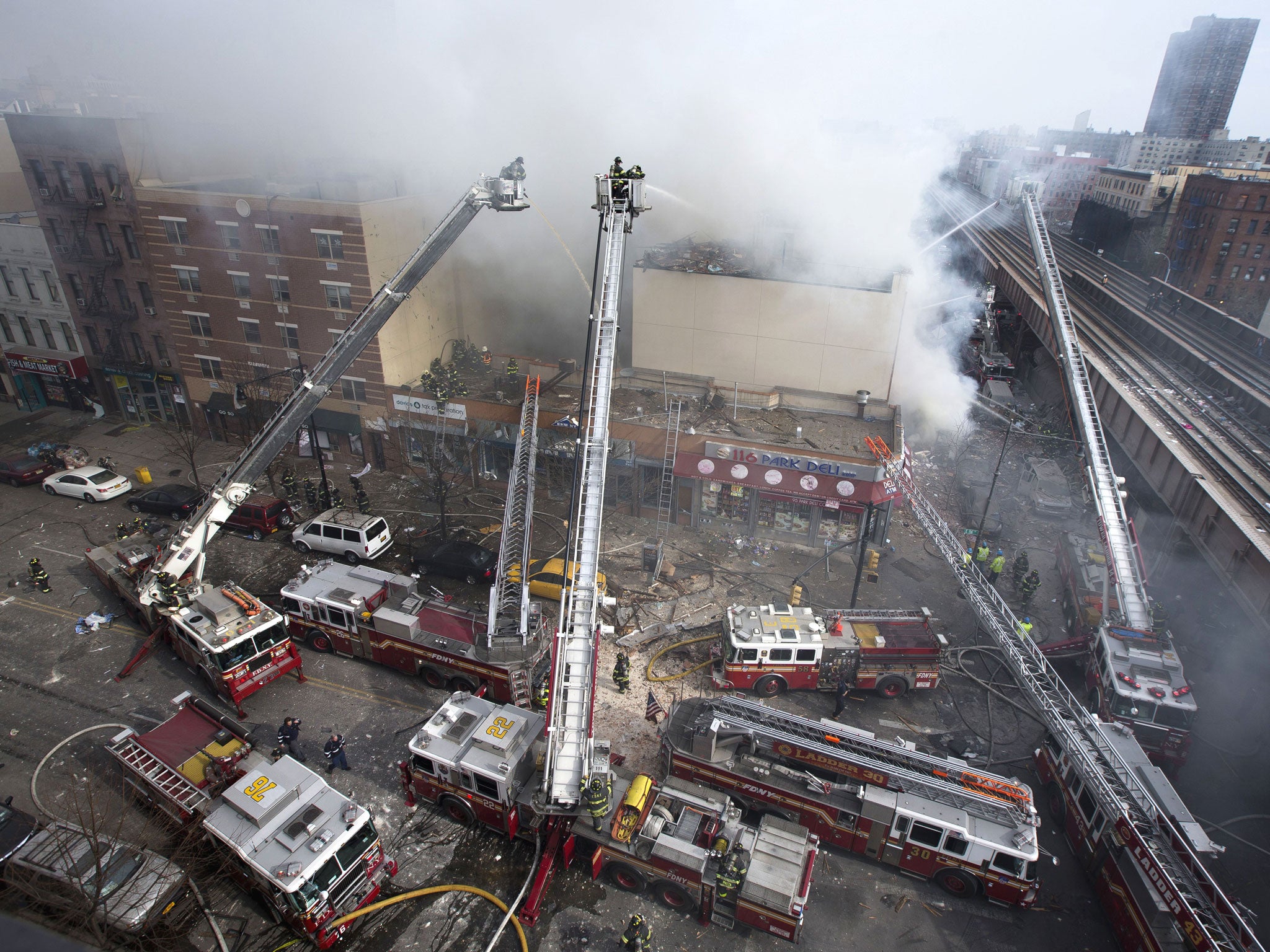 Firefighters battle a fire after a building collapse in the East Harlem neighborhood of New York