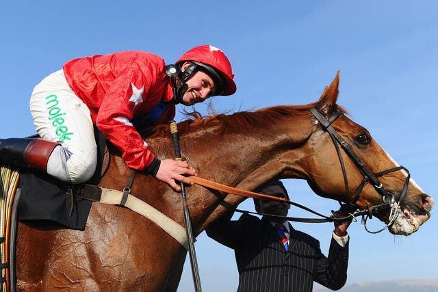 Jamie Moore and Sire de Grugy celebrate victory in the BetVictor Queen Mother Champion Chase during Ladies Day at Cheltenham Festival