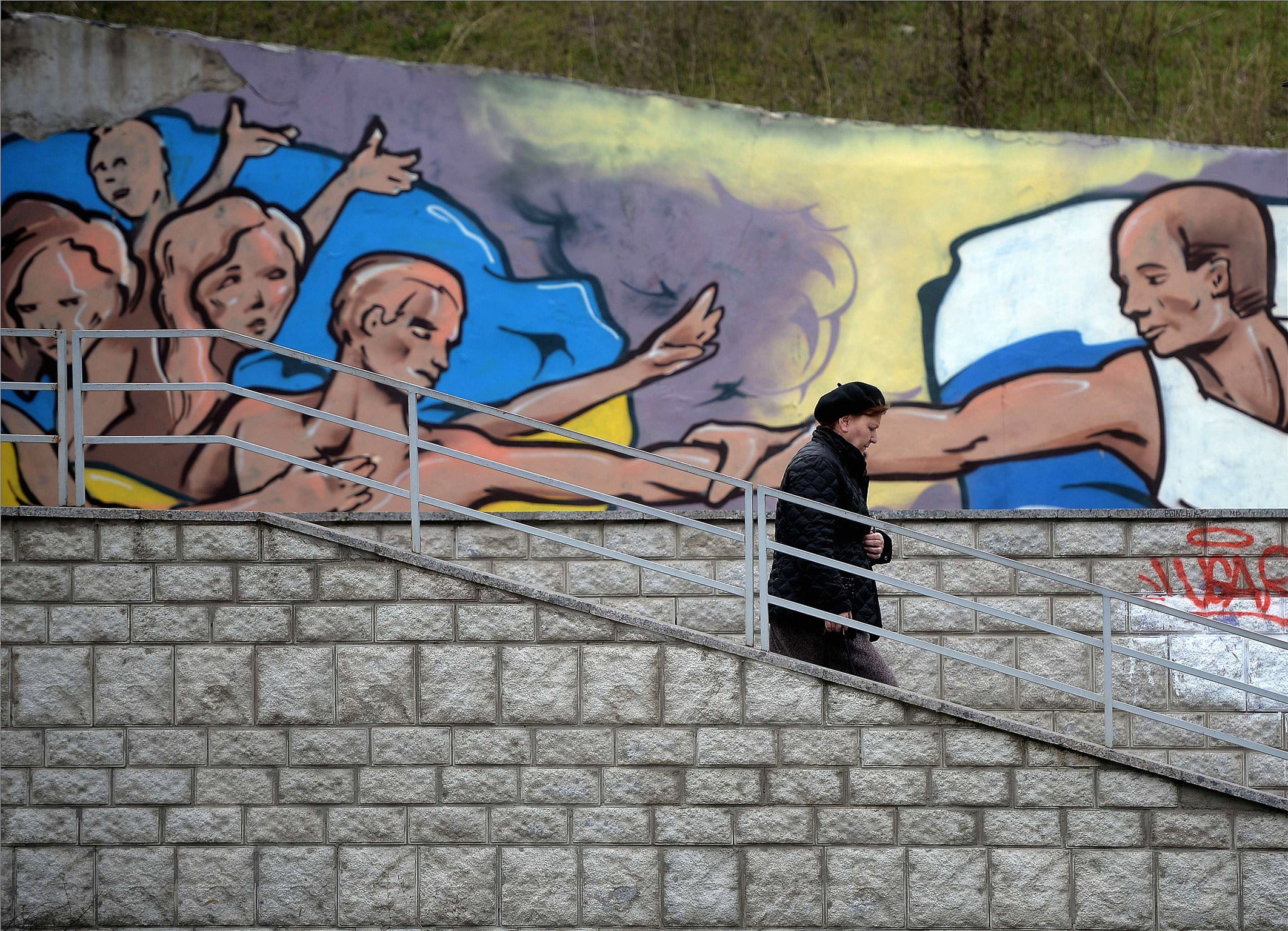 A mural in Simferopol depicts Vladimir Putin giving a hand to Ukrainians