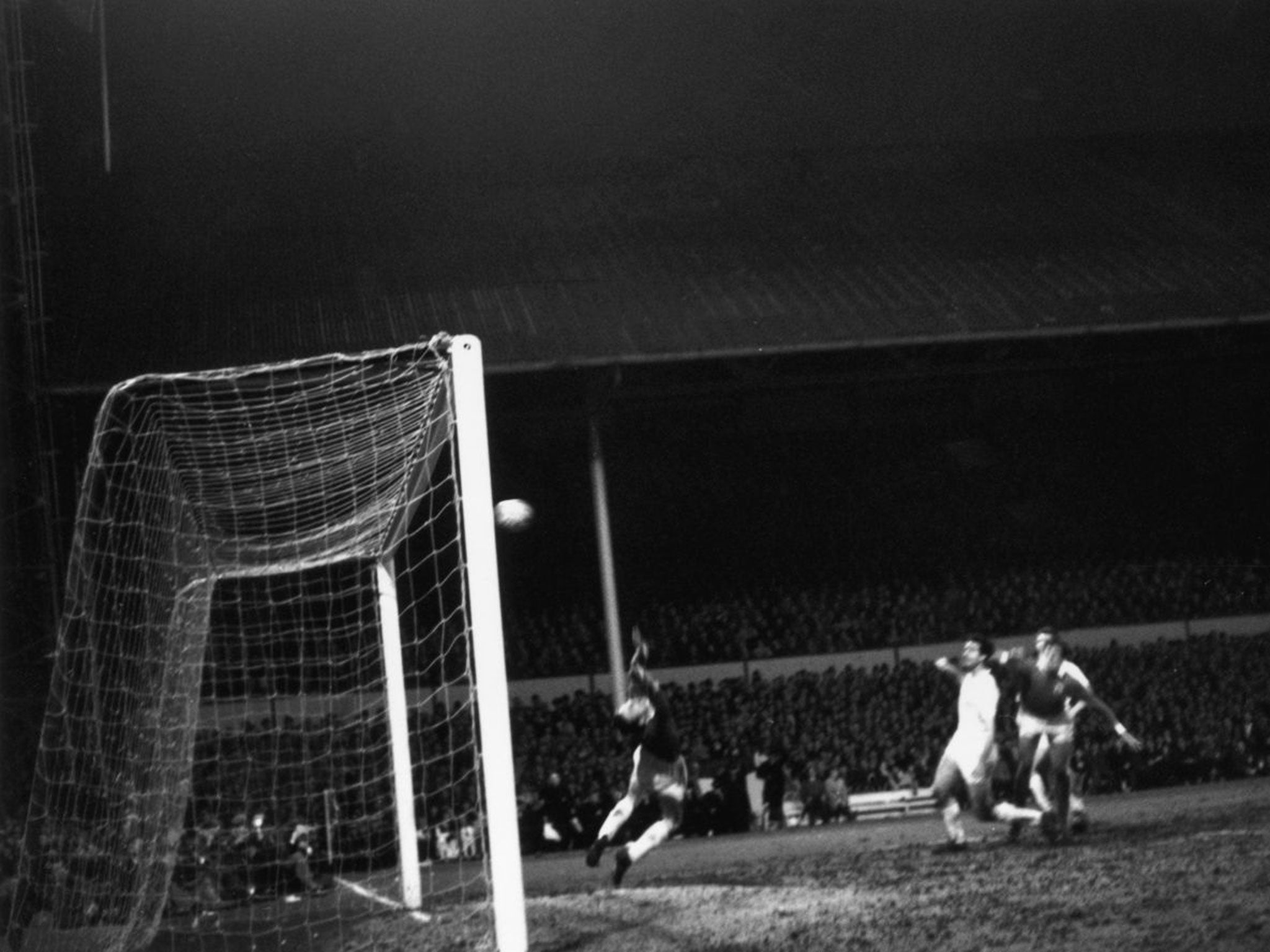 Benfica keeper Costa Pereira saves a header from Maurice Norman