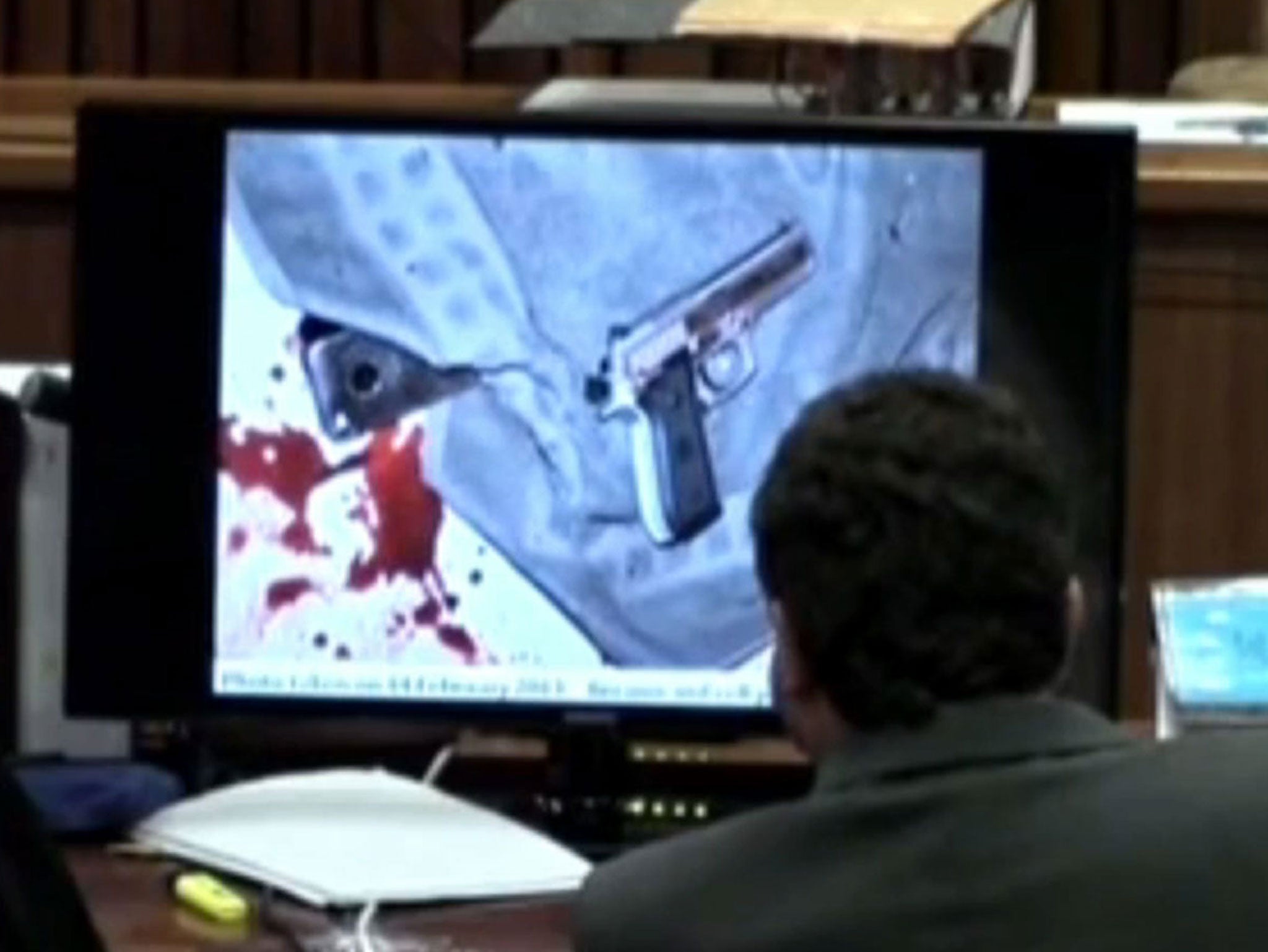 Graphic evidence, including the athlete's blood-stained gun, was shown in court today