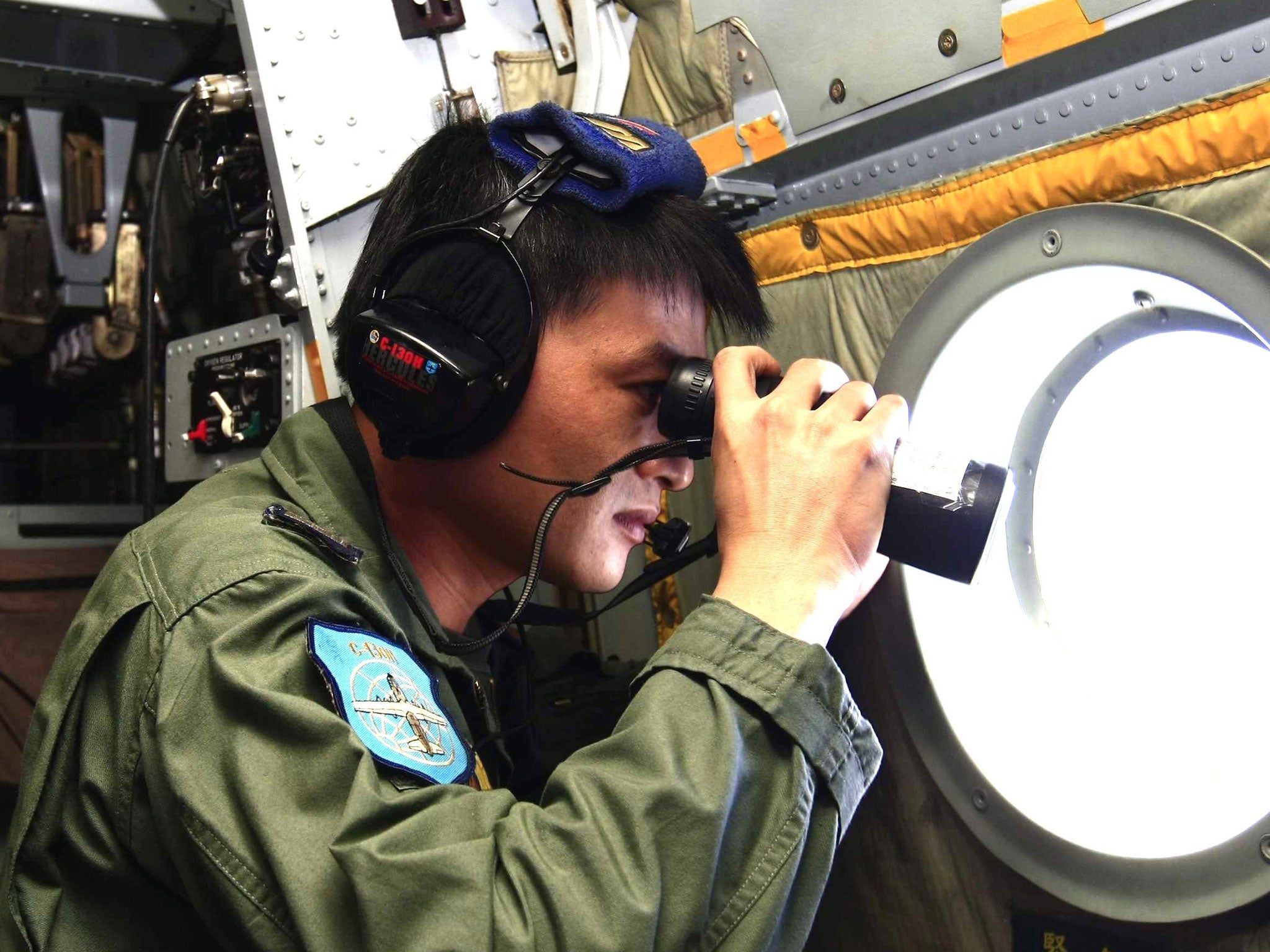 A soldier looking out for the missing Malaysia Airlines plane during earlier searches