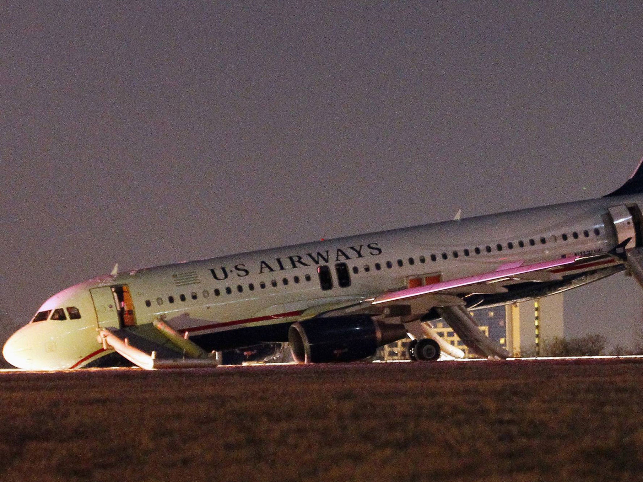 The USAirways plane's nose gear collapsed as the pilot reacted to a tyre bursting during take-off at Philadelphia International Airport