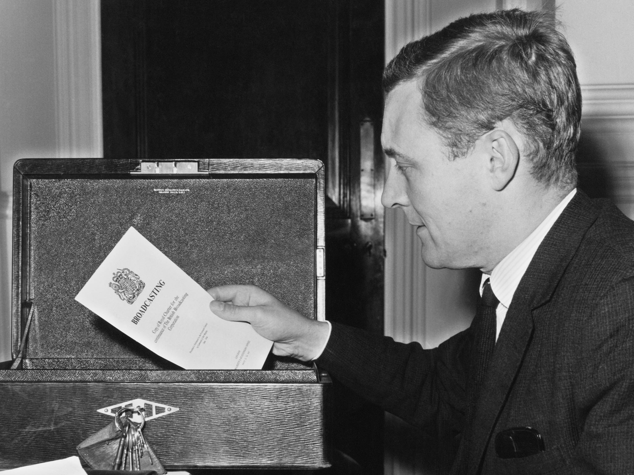 Tony Benn places an official report on broadcasting into his dispatch box on his first day in his new Cabinet role of Postmaster General in 1964