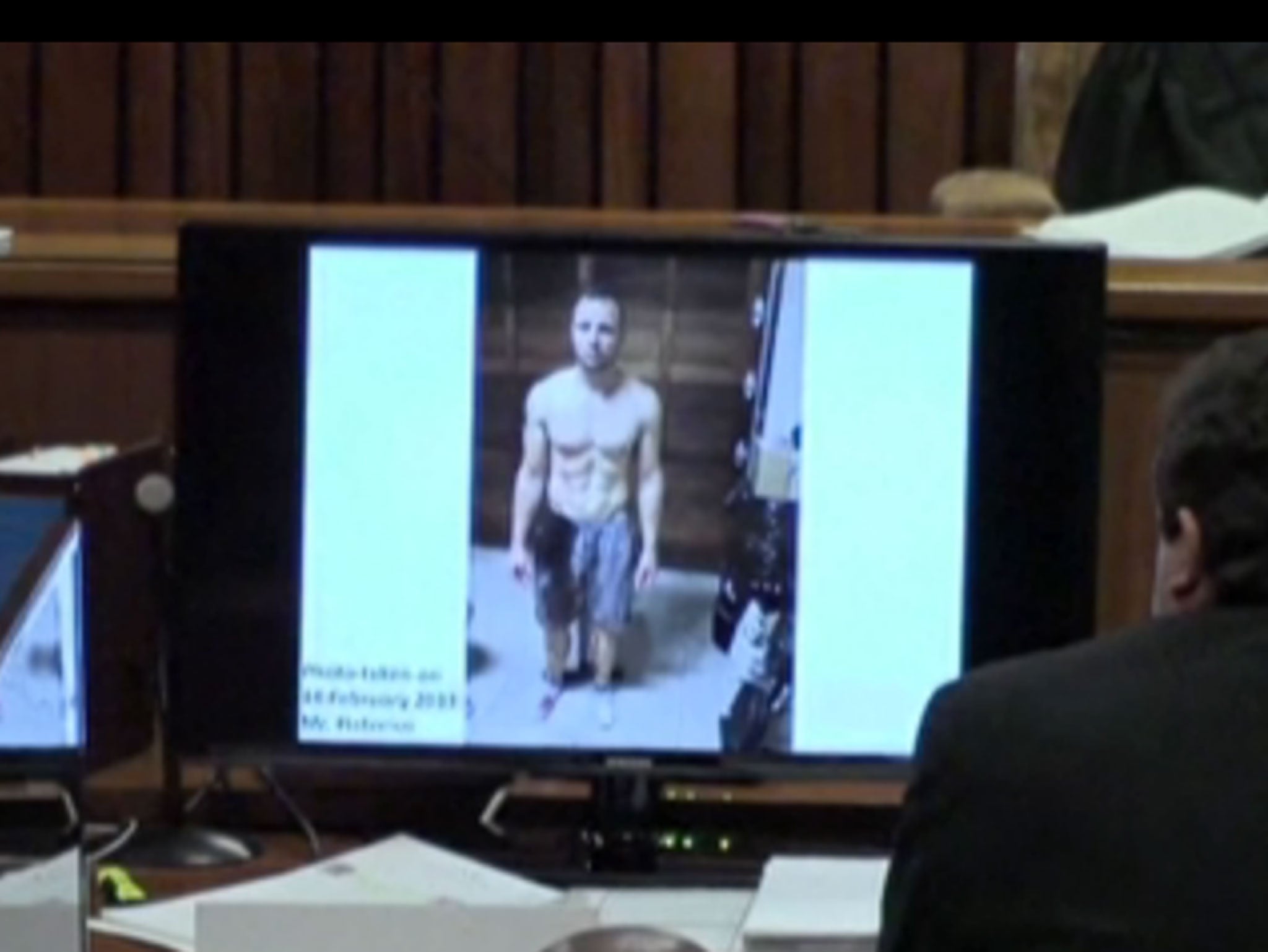 Photographs of Pistorius taken soon after fatal shooting of Reeva Steenkamp were shown in court. The athlete's prosthetic legs are splattered with blood