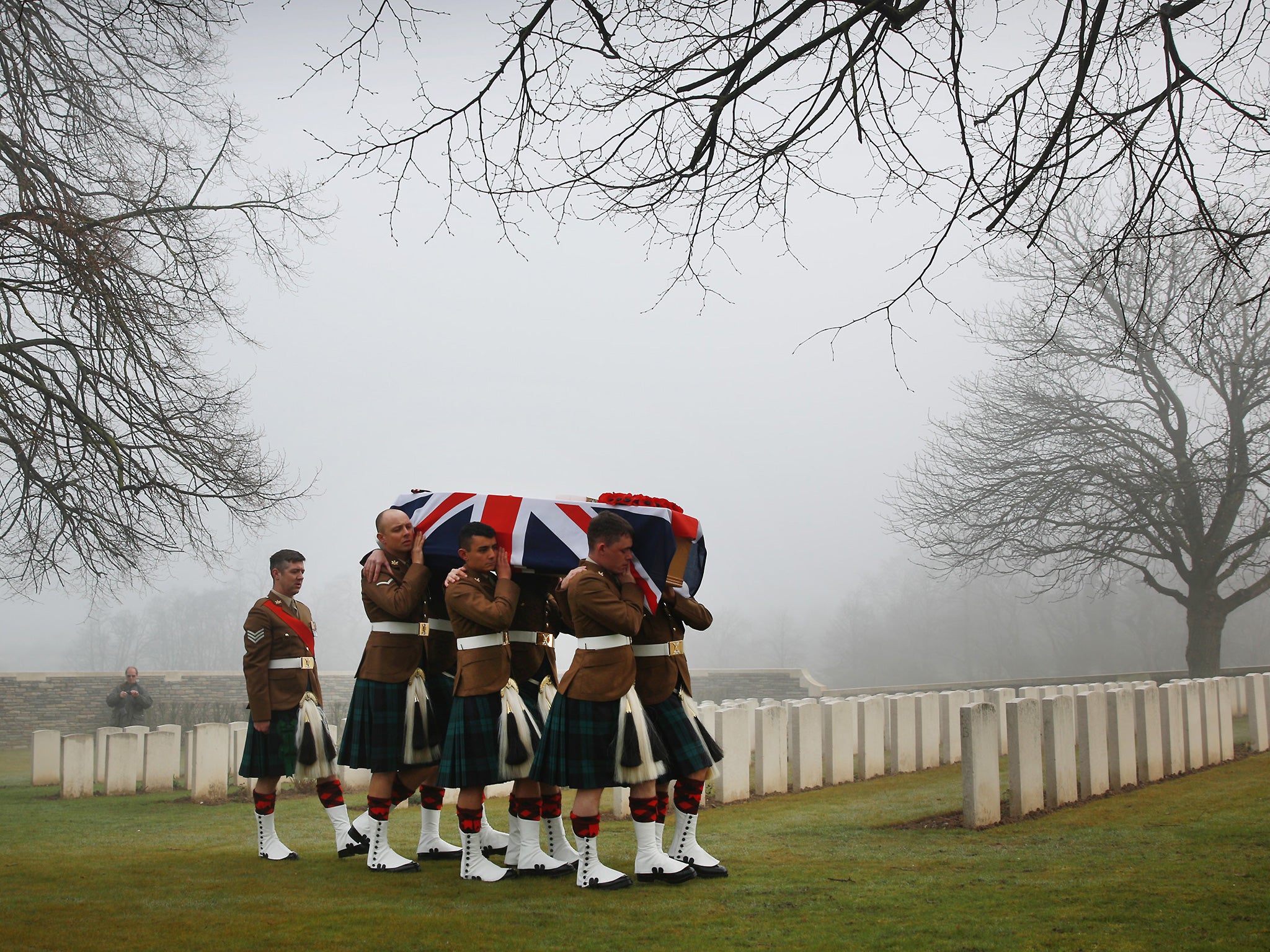 Soldiers of The 2nd Battalion The Royal Regiment of Scotland carry the coffin of Private William McAleer, from the 7th Battalion the Royal Scottish Fusiliers during a re-burial ceremony Loos British Cemetery in Loos-en-Gohelle, France. Almost 100 years af