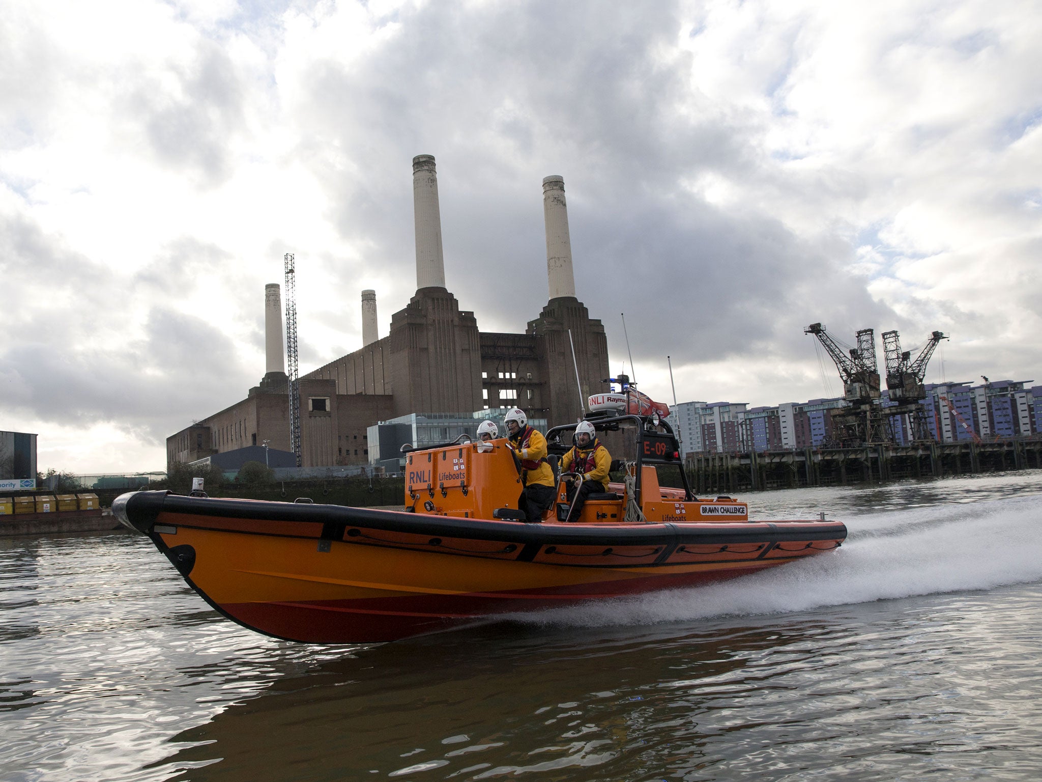 Crew members of the RNLI's Tower Lifeboat station patrol the river Thames.