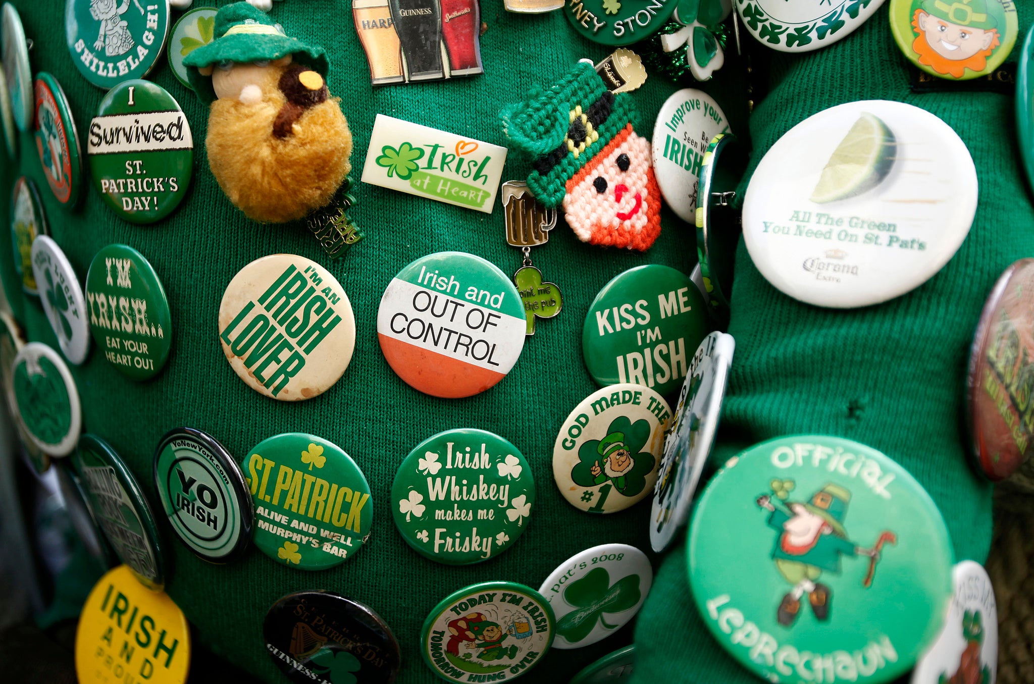 St. Patrick's Day coat pins adorn the jacket of Dennis Dunn of New York as he watches the 251st annual St. Patrick's Day Parade in New York, March 17, 2012.