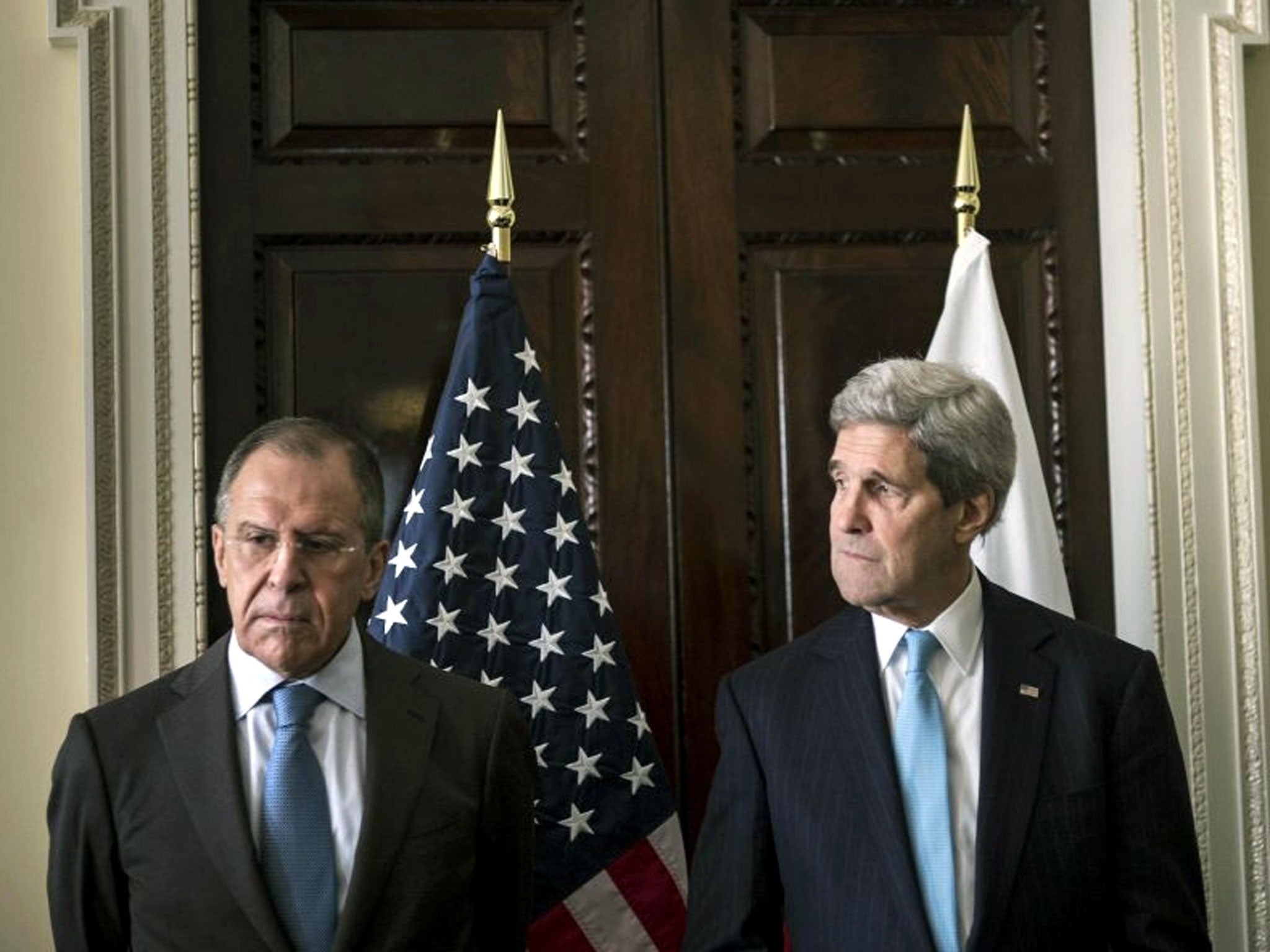 US Secretary of State John Kerry (R) and Russia's Foreign Minister Sergei Lavrov stand together before their meeting at Winfield House, the home of the US ambassador in London.