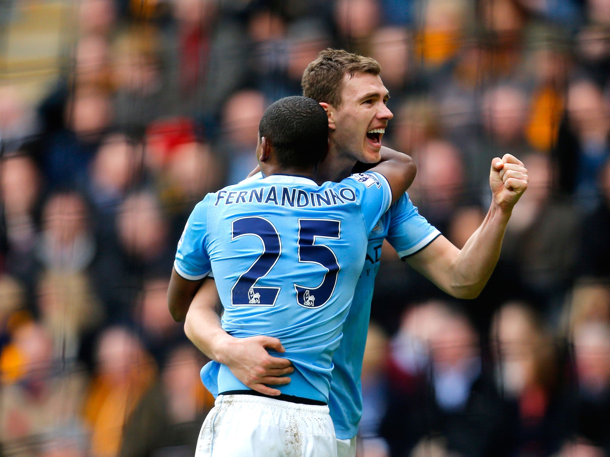 Edin Dzeko of Manchester City celerates with teammate Fernandinho