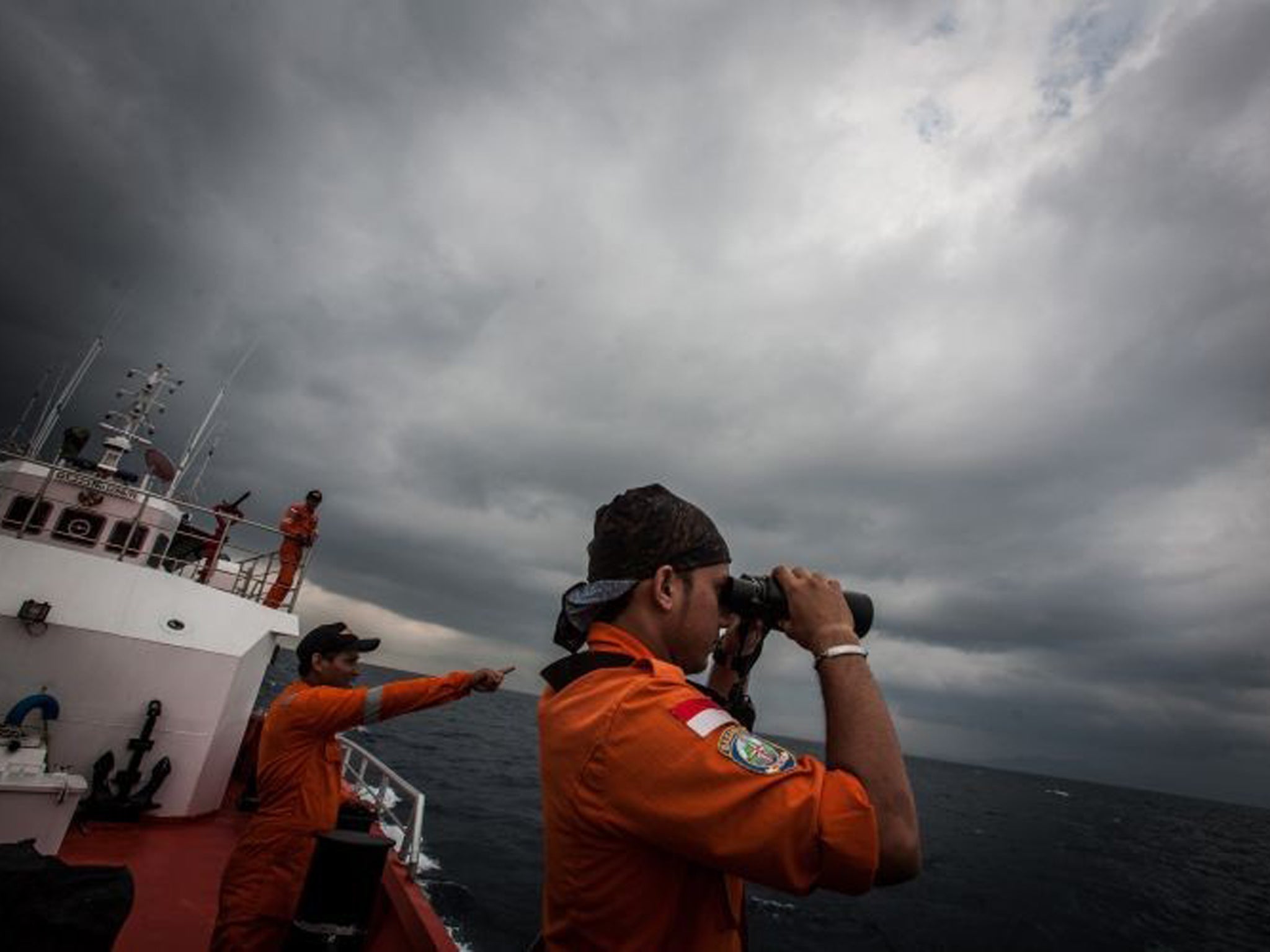 Indonesian search and rescue workers survey high seas as part of the search mission