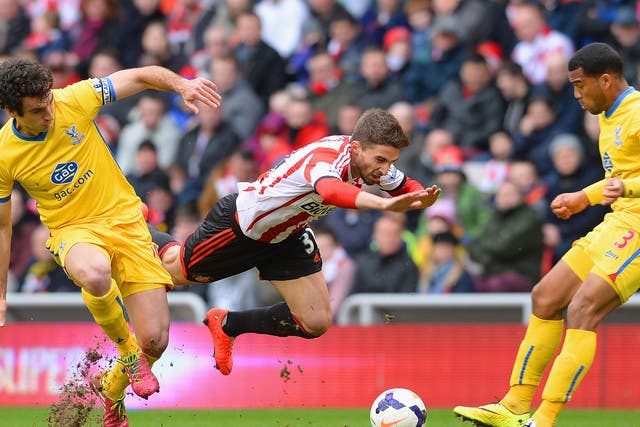 Fabio Borini of Sunderland clashes with Mile Jedinak and Adrian Mariappa of Crystal Palace
