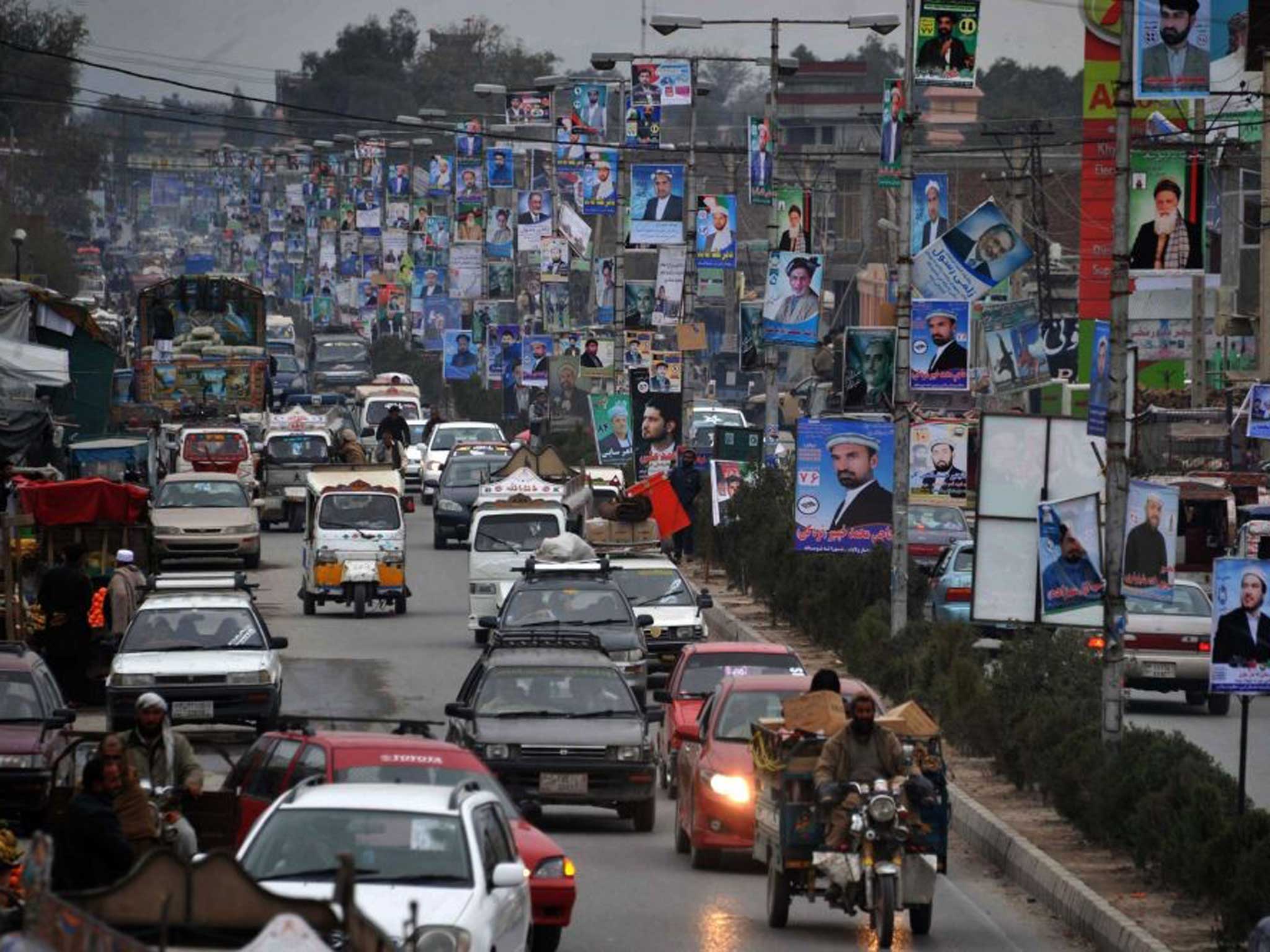 Poster power: Candidates’ faces line a road in Jalalabad yesterday