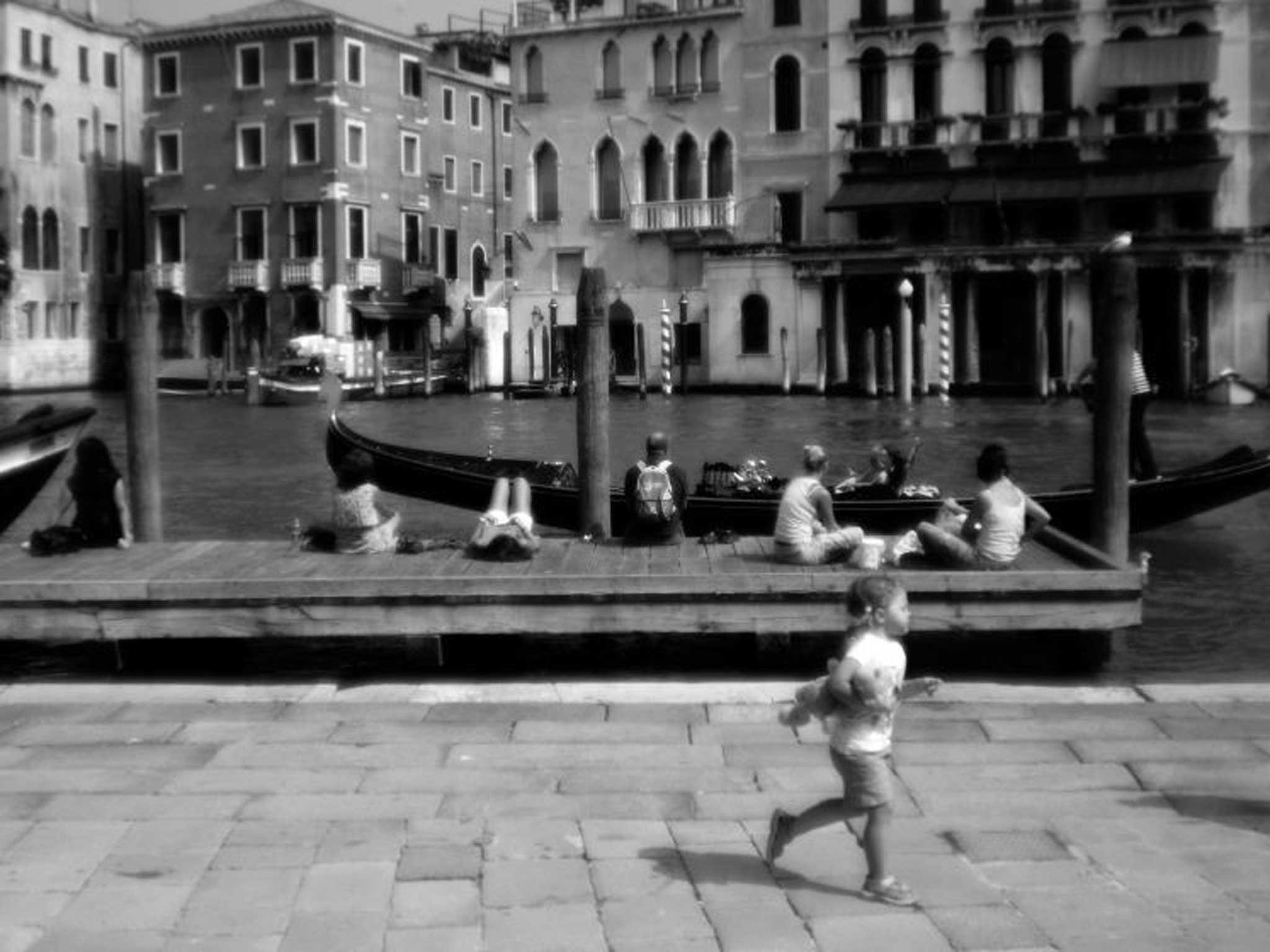 Tourists relax beside the Grand Canal, Venice