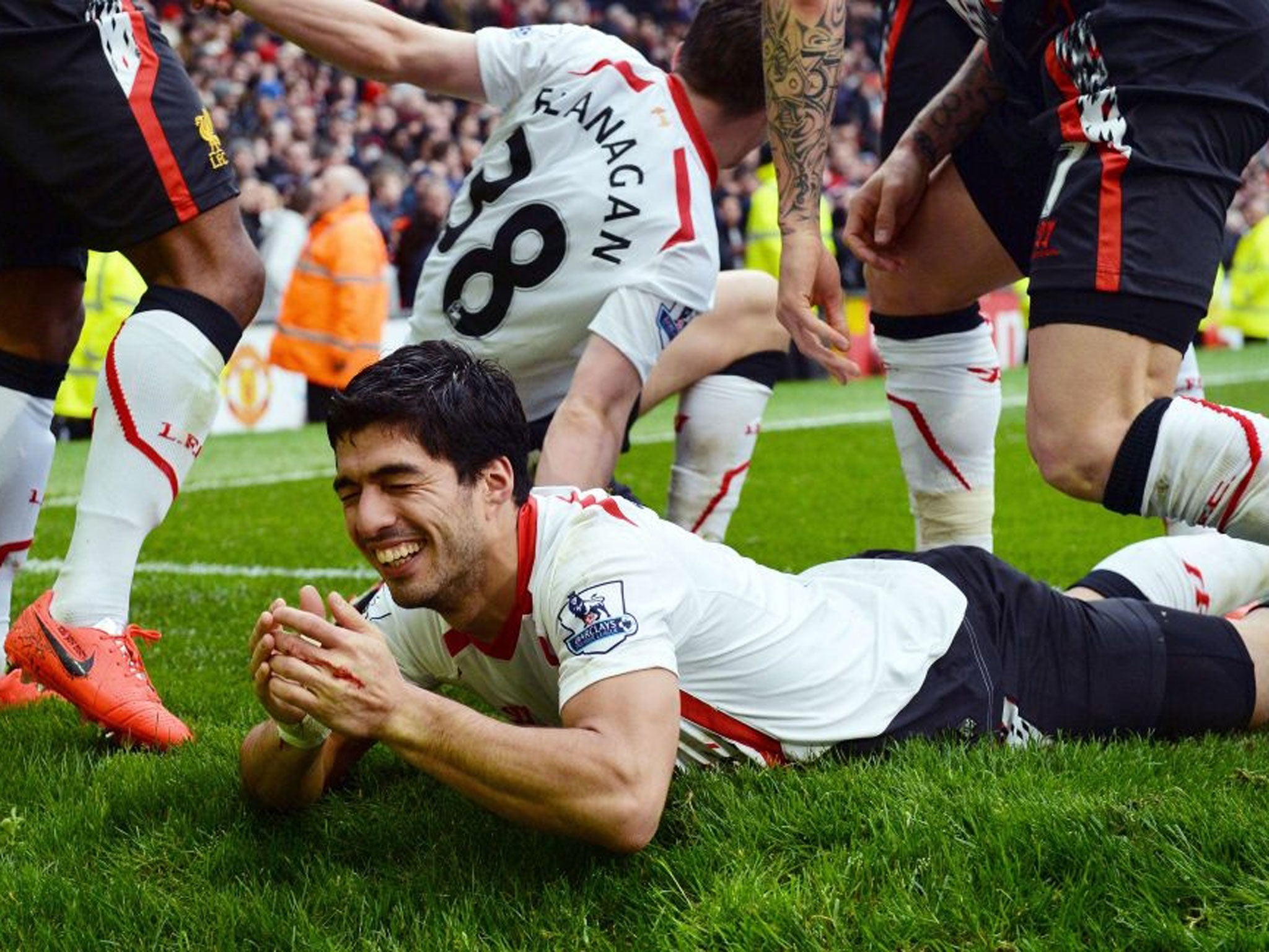 Liverpool's Uruguayan striker Luis Suarez celebrates scoring his team's third goal during the English Premier League football match between Manchester United and Liverpool at Old Trafford in Manchester
