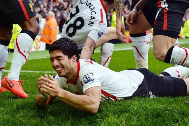 Liverpool's Uruguayan striker Luis Suarez celebrates scoring his team's third goal during the English Premier League football match between Manchester United and Liverpool at Old Trafford in Manchester