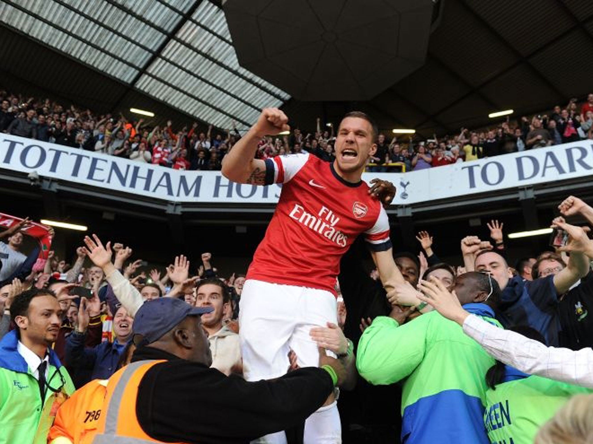 Lukas Podolski celebrates with the Arsenal fans after the Barclays Premier League match between Tottenham Hotspur and Arsenal at White Hart Lane (Getty)