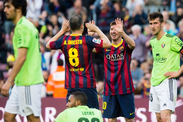 Lionel Messi pictured celebrating with Andres Iniesta on his way to a hat-trick in a 7-0 win over Osasuna