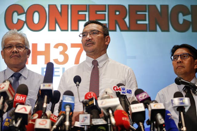 Malaysia's acting Transport Minister Hishammuddin Hussein (C) is accompanied by Deputy Foreign Minister Hamzah Zainudin (L) and Department of Civil Aviation's Director General Azharuddin Abdul Rahman as he addresses reporters about the missing Malaysia Airlines Flight MH370, at Kuala Lumpur International Airport March 17, 2014