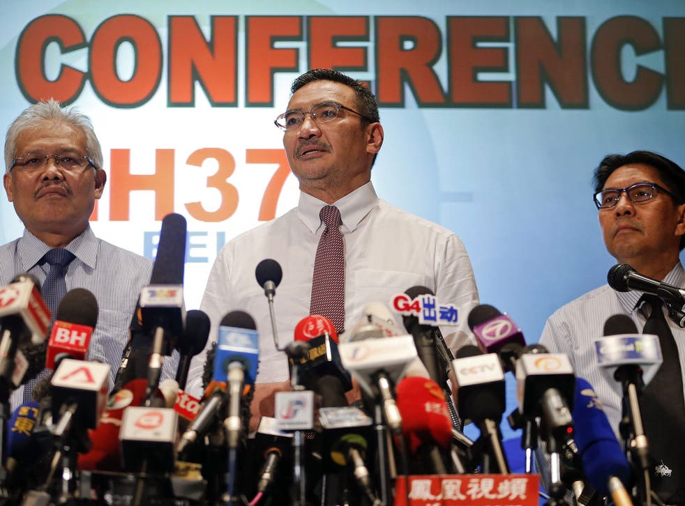 Malaysia's acting Transport Minister Hishammuddin Hussein (C) is accompanied by Deputy Foreign Minister Hamzah Zainudin (L) and Department of Civil Aviation's Director General Azharuddin Abdul Rahman as he addresses reporters about the missing Malaysia Airlines Flight MH370, at Kuala Lumpur International Airport March 17, 2014