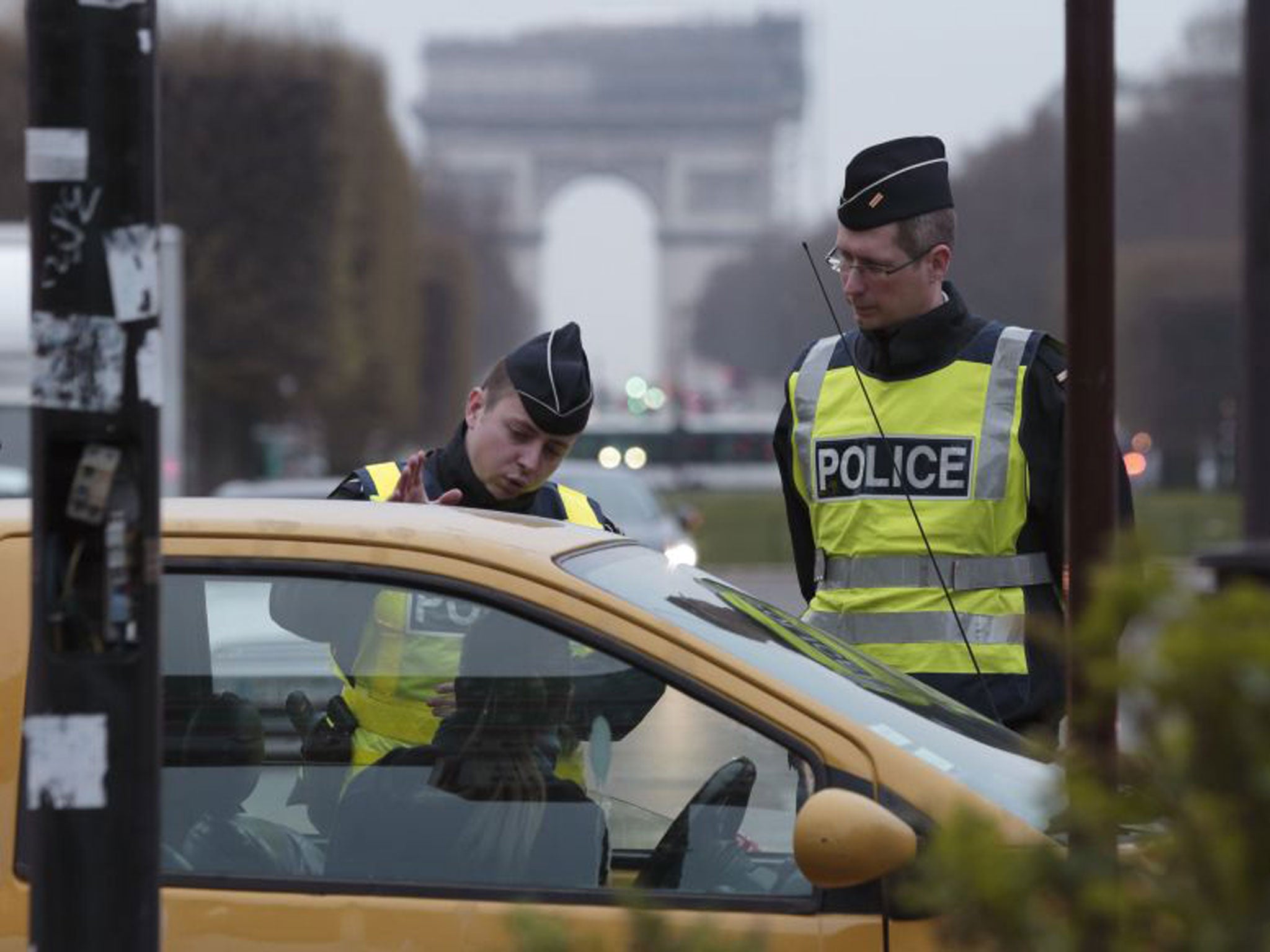 Police stop a driver with an even-numbered car in Paris yesterday