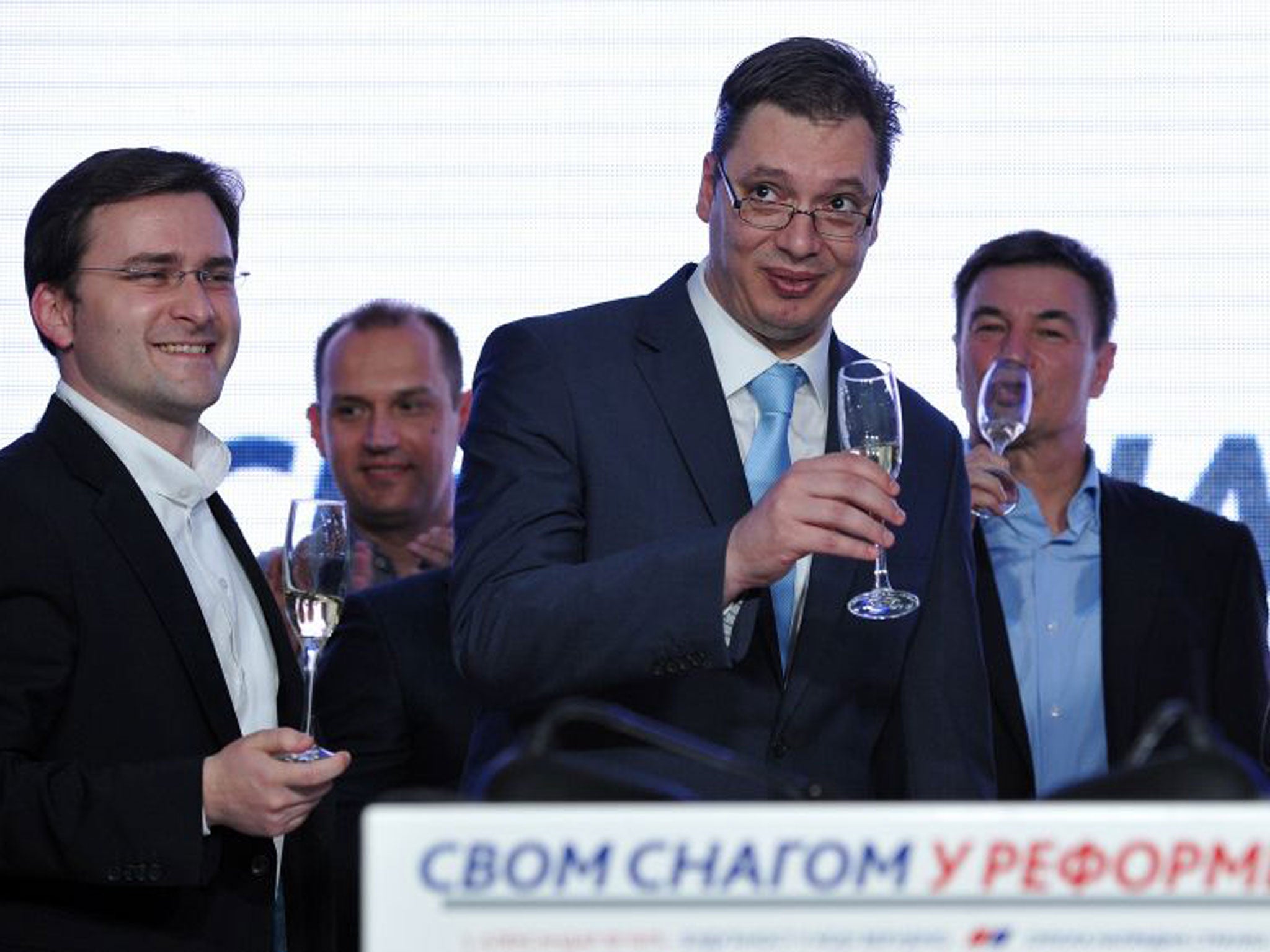 Deputy Prime Minister Aleksandar Vucic, and leader of the ruling Serbian Progressive Party (SNS), centre, celebrates after a landslide victory