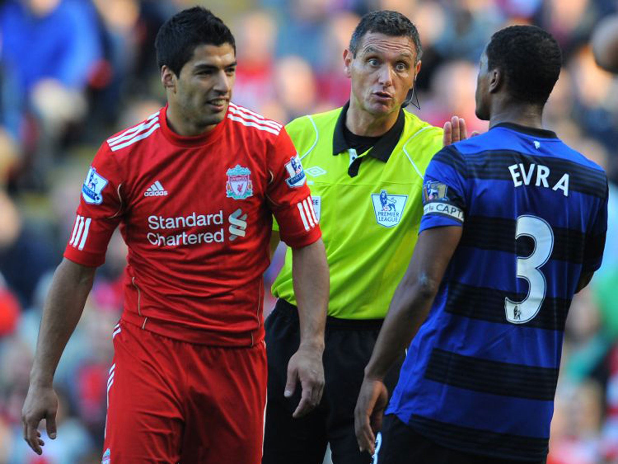 Referee Andrew Marriner comes between Luis Suarez and Patrice Evra in an infamous racial incident in October 2011