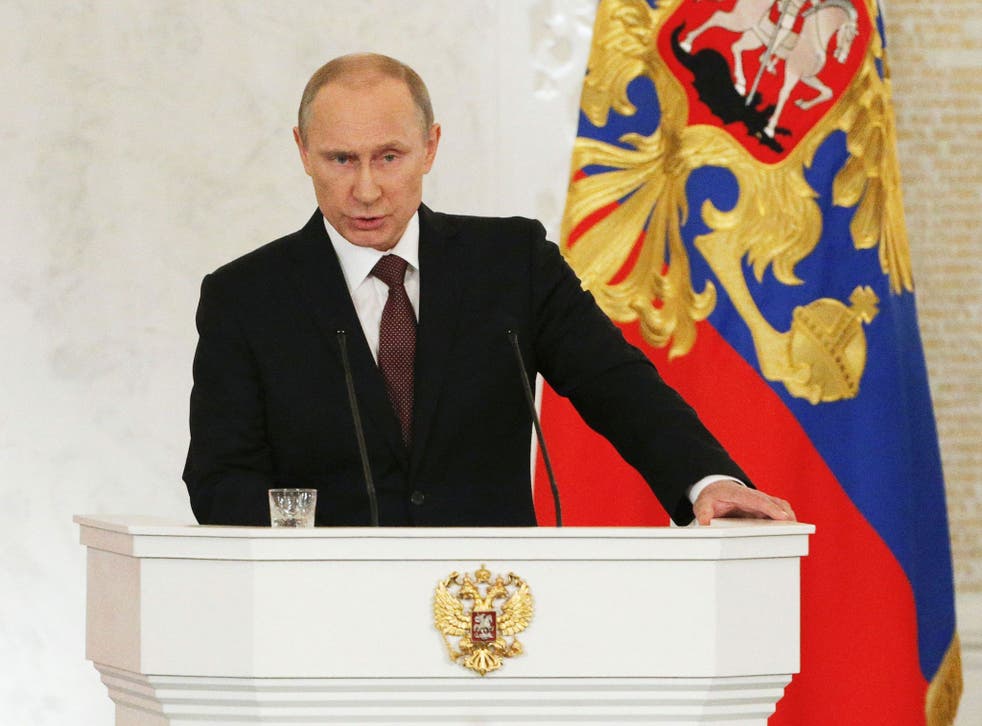 Russian President Vladimir Putin addresses the Federal Assembly, including State Duma deputies, members of the Federation Council, regional governors and civil society representatives, at the Kremlin in Moscow March 18, 2014