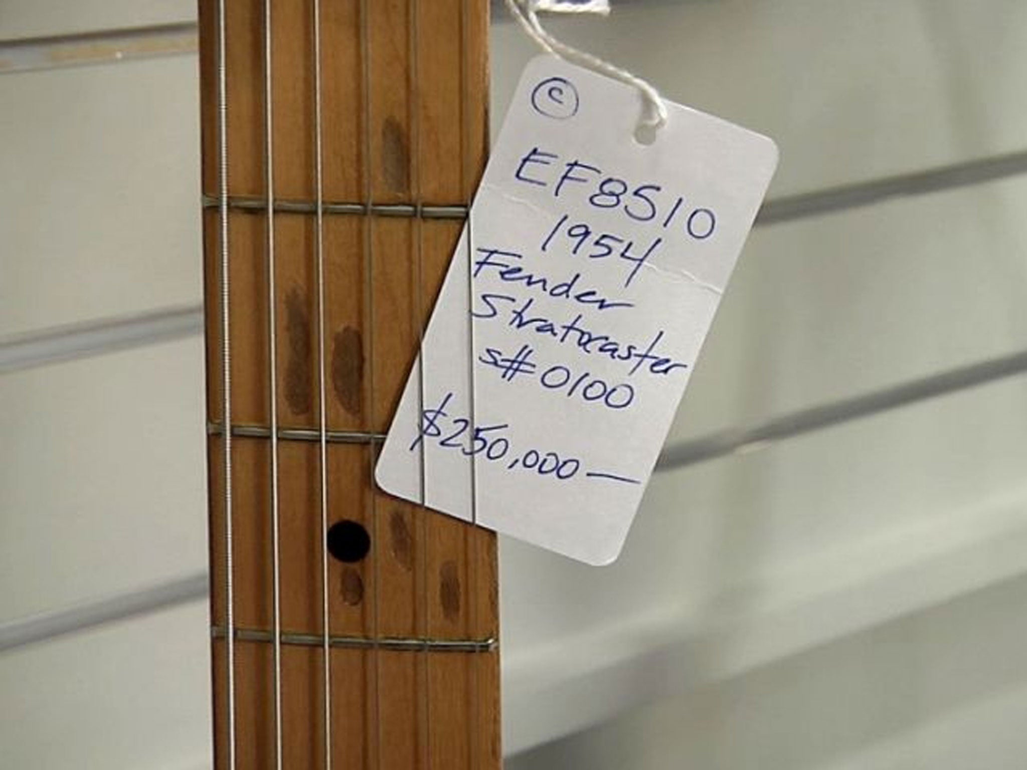 A store tag showing the price for the first production model Fender Stratocaster guitar