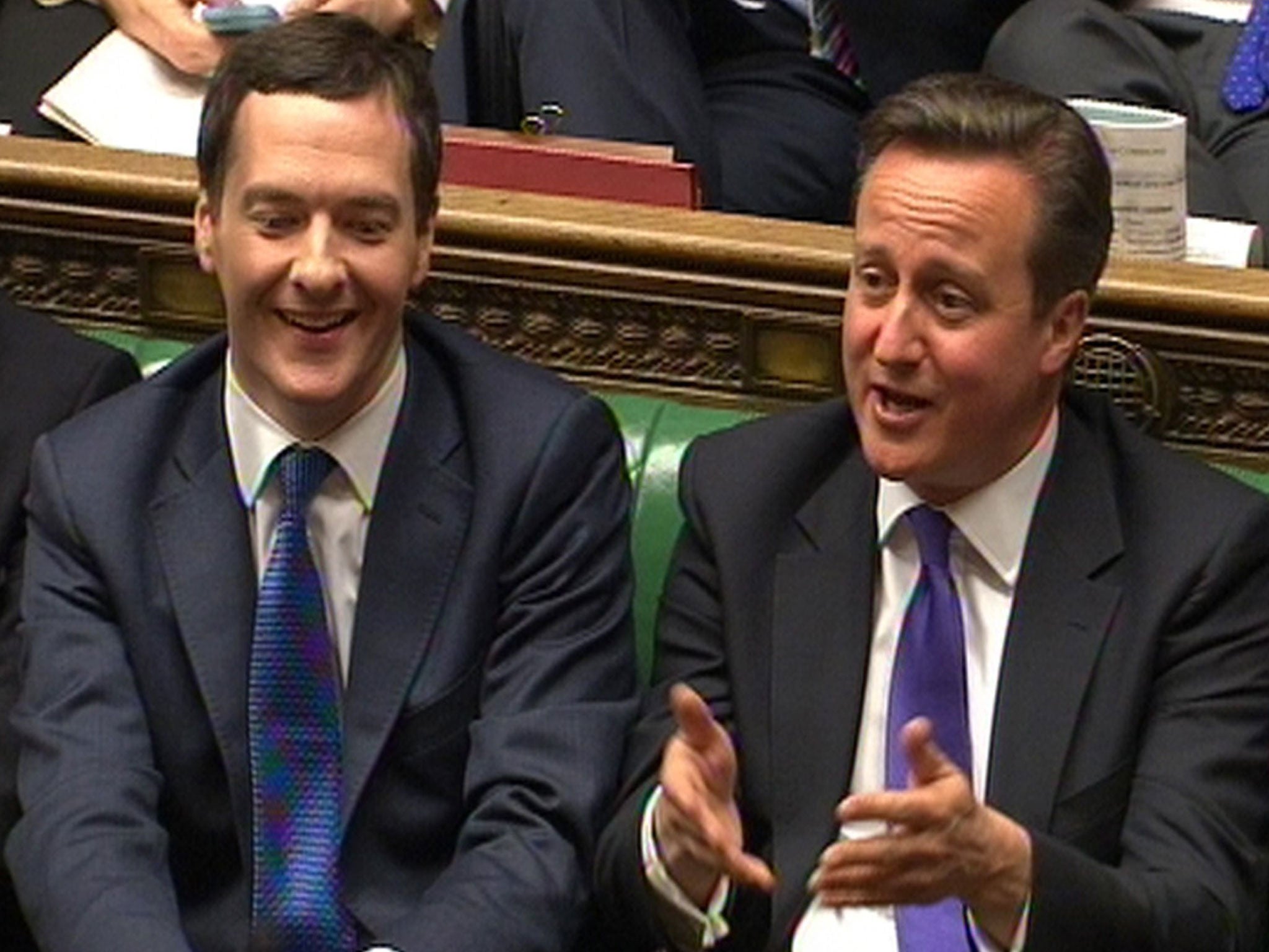 Chancellor of the Exchequer George Osborne and Prime Minister David Cameron laugh as Labour party leader Ed Miliband responds to his Budget statement to the House of Commons