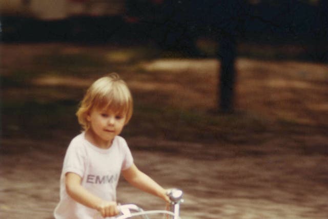 Emma as a four-year-old cycling around a French campsite on her favourite red bike