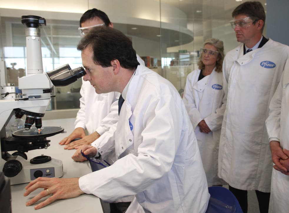Chancellor George Osborne looks through a microscope at Pfizer's pharmaceutical science lab in 2011