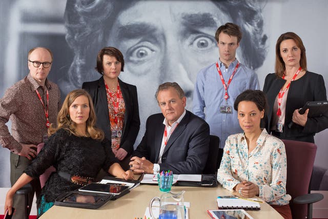 The cast of the BBC satire ‘W1A’, overseen by the quizzical eyes of Frankie Howerd