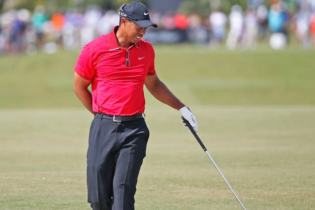 Tiger Woods clutches his painful lower back at Doral a fortnight ago