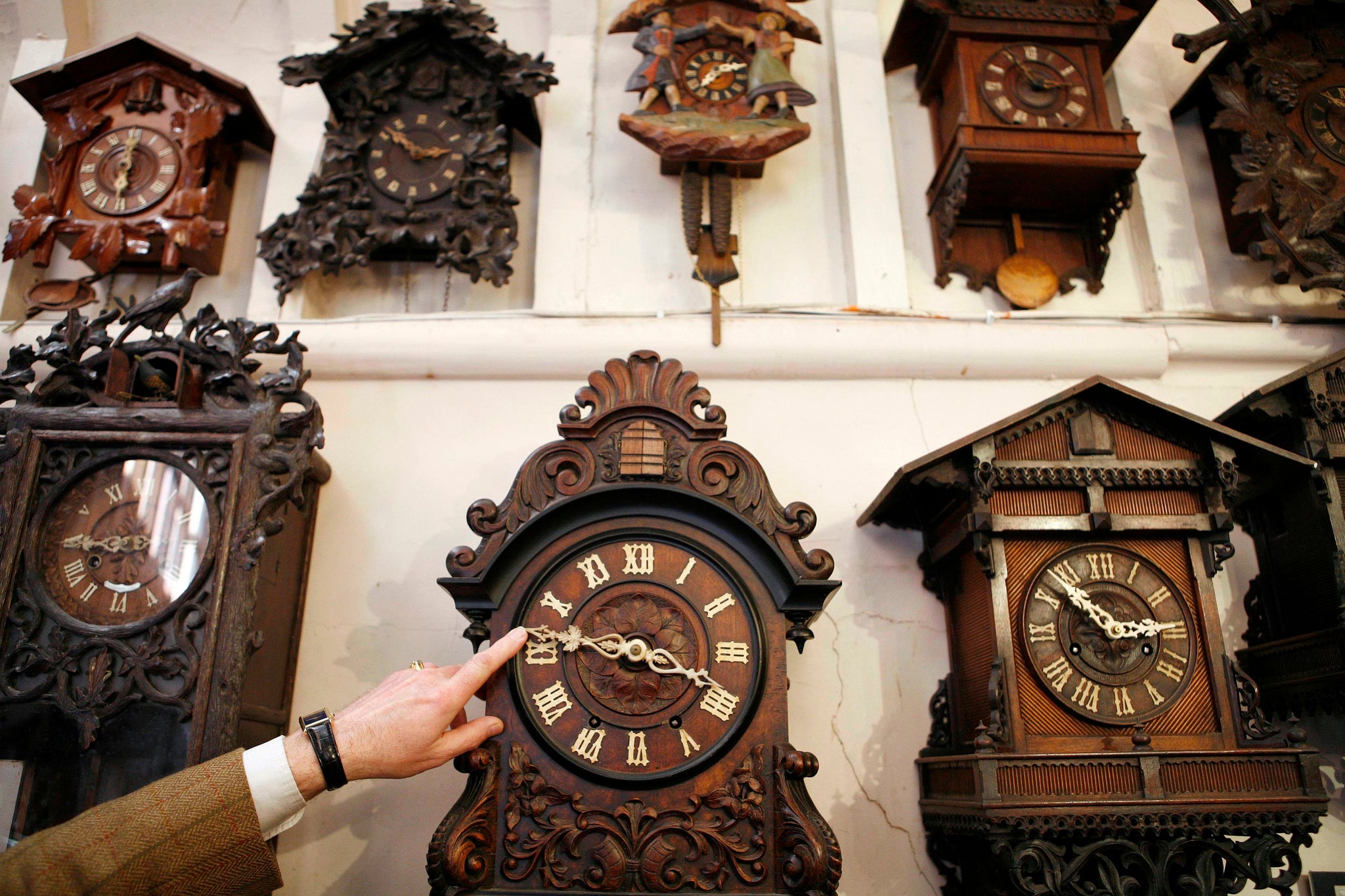 Roman Piekarski adjusts the hands on one of the clocks at Cuckoo Land, his cuckoo clock museum, near Knutsford in northern England, 2009. The museum takes two-days to turn its 600 clocks forward by one hour in preparation for the arrival of British Summer Time.