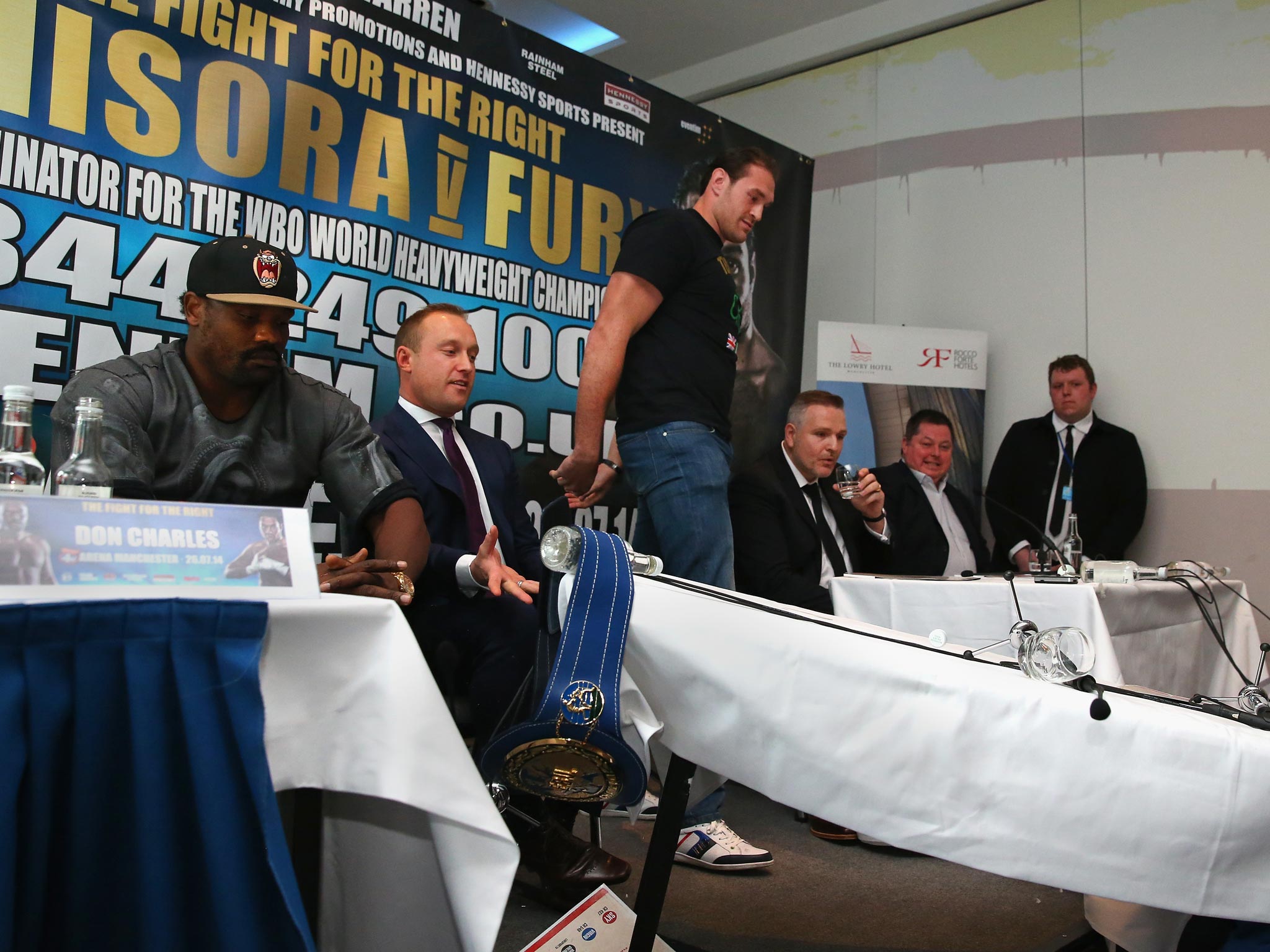 Tyson Fury storms out of press conference after flipping a table and a foul-mouthed tirade as Dereck Chisoara looks on