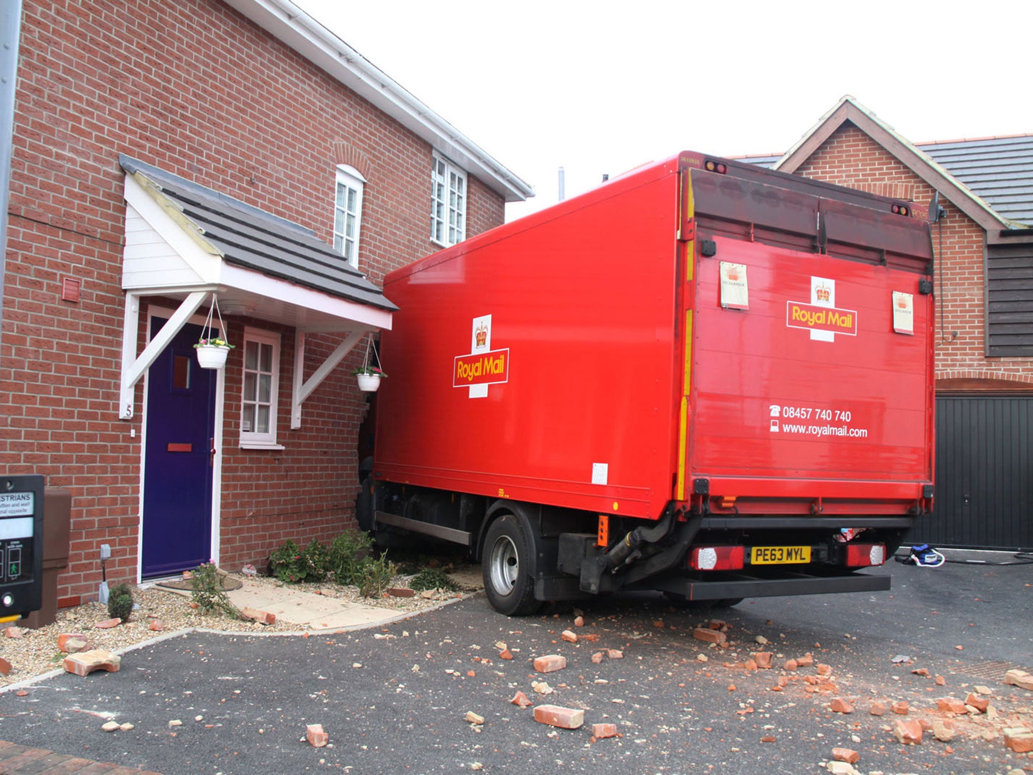 Handout photo dated 20/03/14 issued by Hampshire Fire and Rescue Service of a 7.5 tonne Royal Mail lorry that has crashed into the side of a house in Gosport
