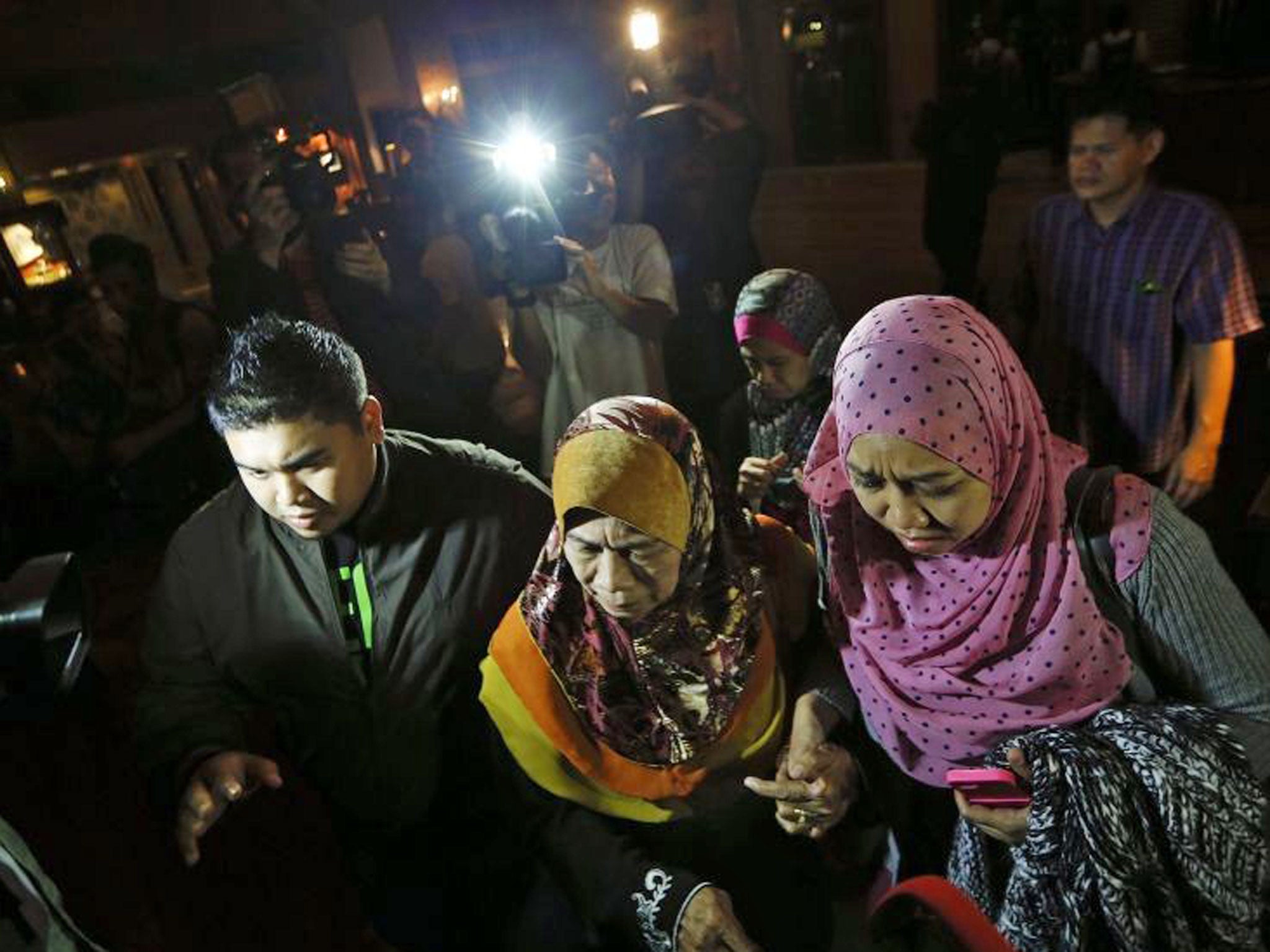 Family members of missing Malaysia Airlines flight MH370 passengers arrive for a briefing on the current situation at a hotel where other passenger's relatives are in Cyberjaya, outside Kuala Lumpur