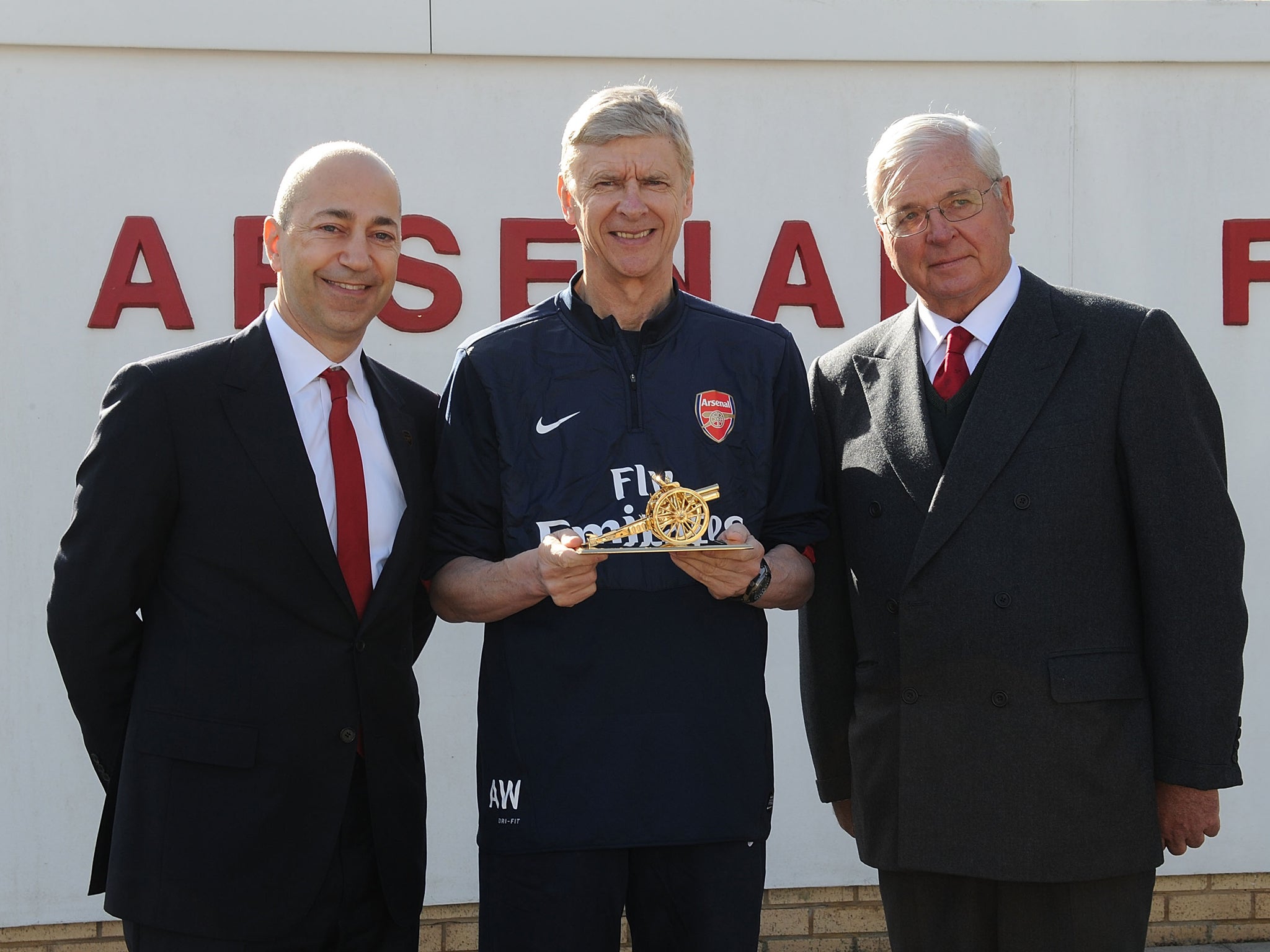 Chairman Sir Chips Keswick and CEO Ivan Gazidis present Arsene Wenger with a gold cannon to commemorate his 1000th game as Arsenal manager at London Colney