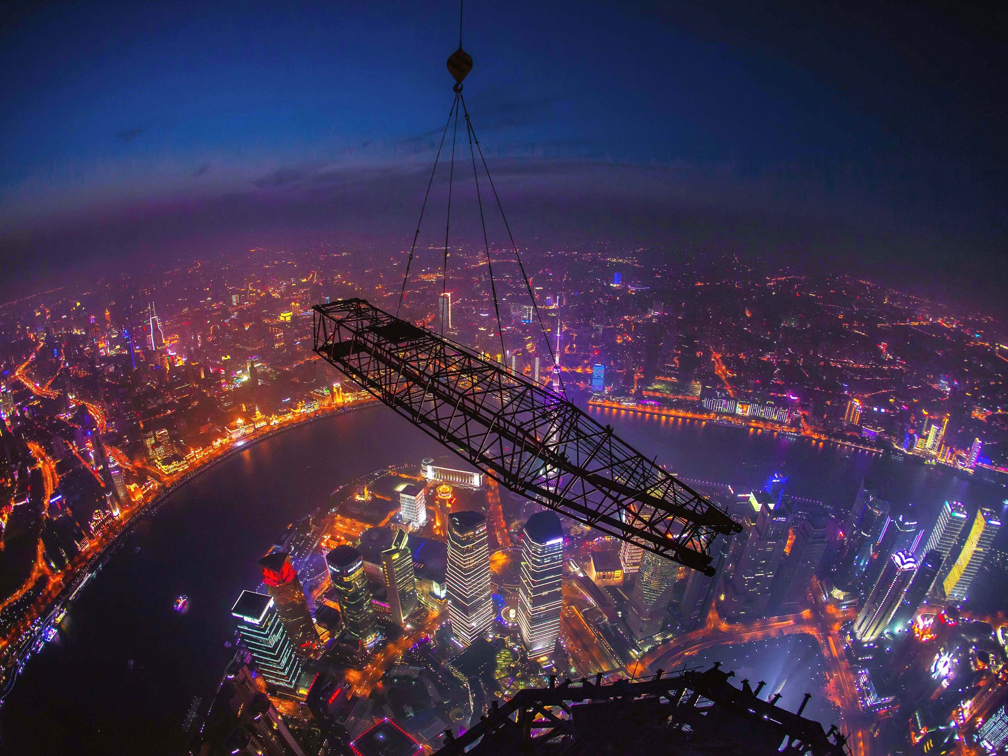Cranes that have helped to build the Shanghai Tower, China's tallest building and the world's 2nd tallest, are seen being dismantled