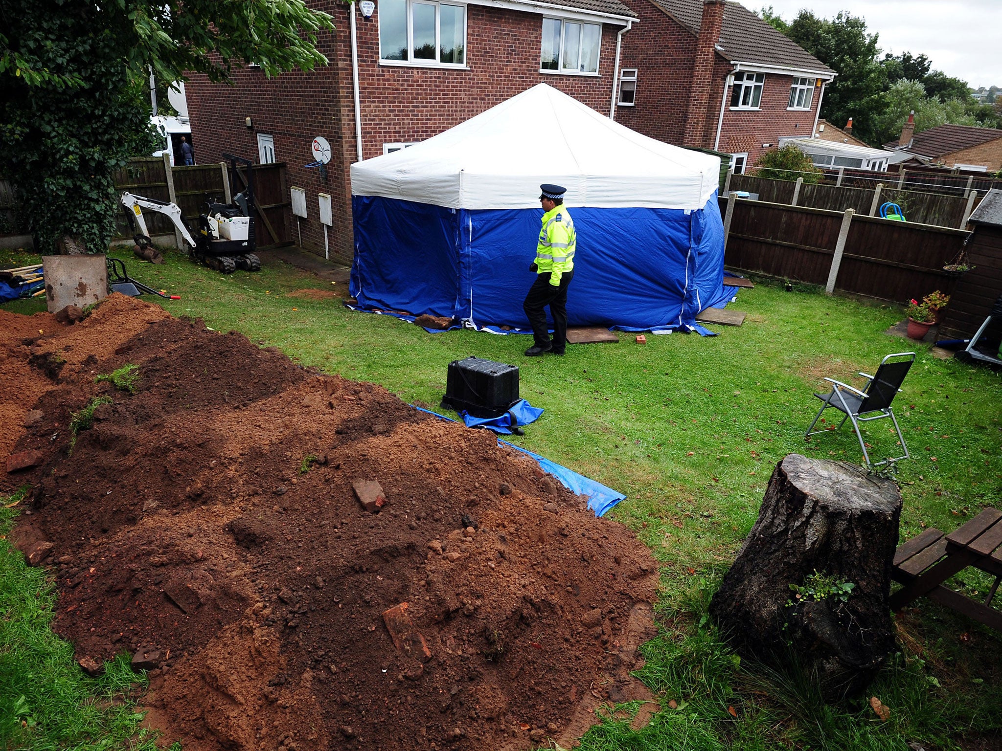 Police in the garden of a house in Blenheim Close, Forest Town, near Mansfield, where the remains of William and Patricia Wycherley discovered, as their daughter Susan Edwards, 55, and her husband Christopher, 57, ave admitted burying her parents in the b