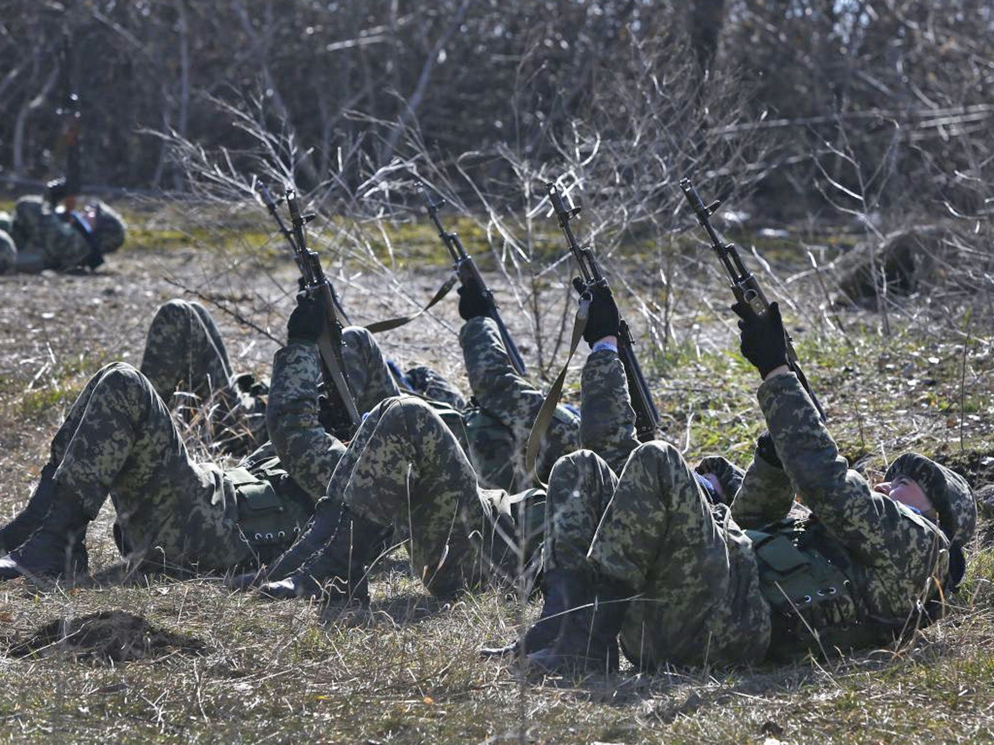 Ukrainian border guards perform an exercise in anti-air attack during training at a military camp in the village of Alekseyevka on the Ukrainian-Russian border, eastern Ukraine