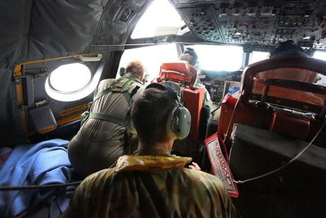 A crew member on a Royal Australian Air Force AP-3C Orion aircraft participating in the Australian Maritime Safety Authority-led search for Malaysia Airlines Flight MH370 in the Southern Indian Ocean