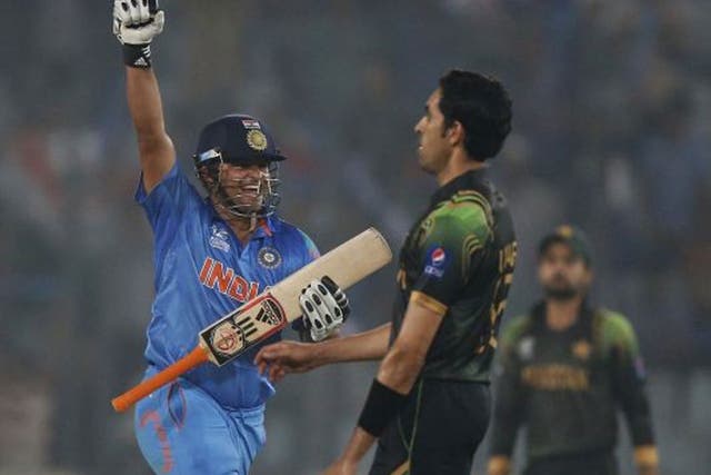 India's batsman Suresh Raina, left, celebrates their victory over Pakistan in the ICC Twenty20 Cricket World Cup match in Dhaka