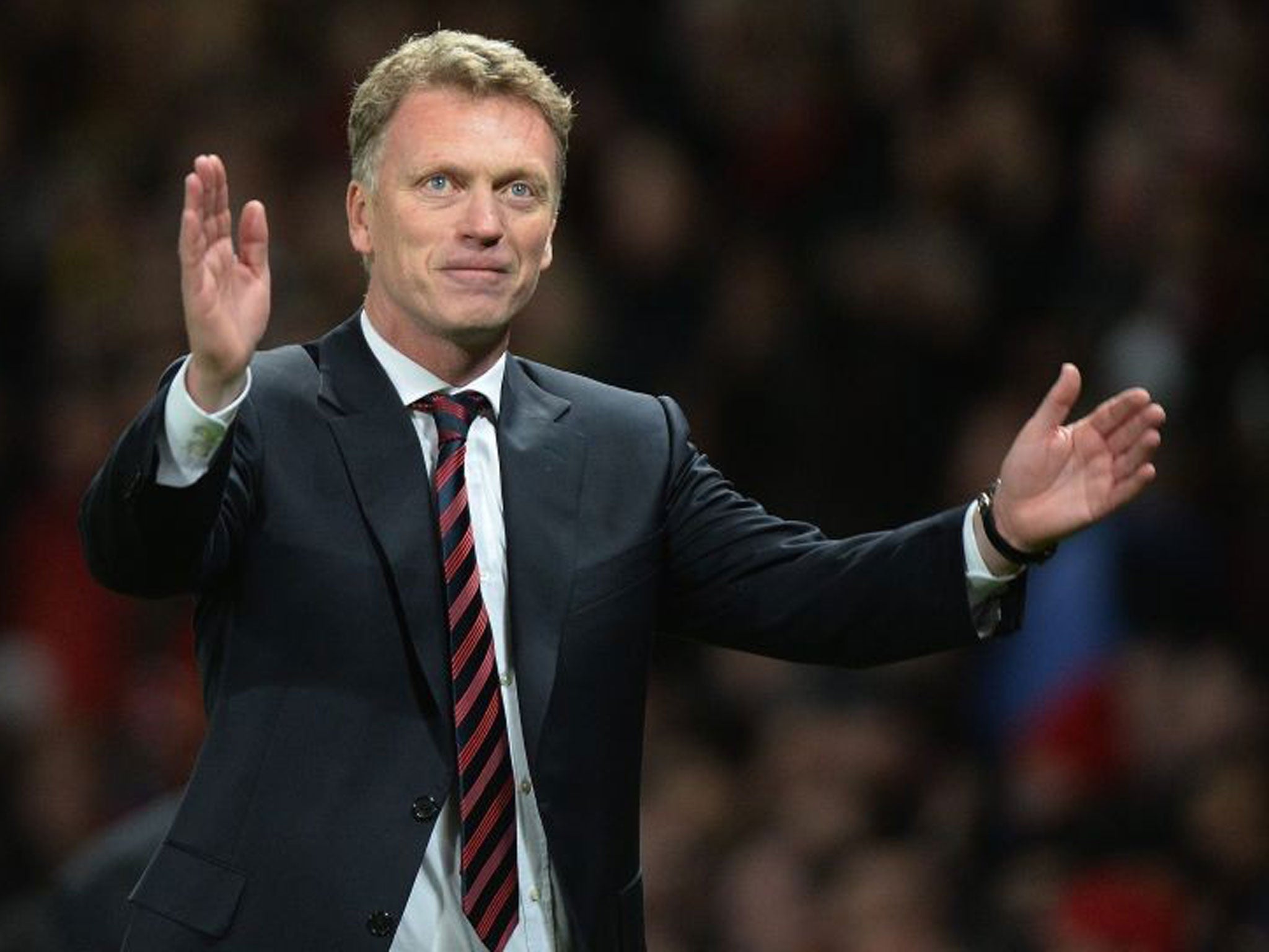 David Moyes celebrates Manchester United's 3-0 victory after the UEFA Champions League round of 16 second leg soccer match between Manchester United and Olympiacos FC at Old Trafford in Manchester