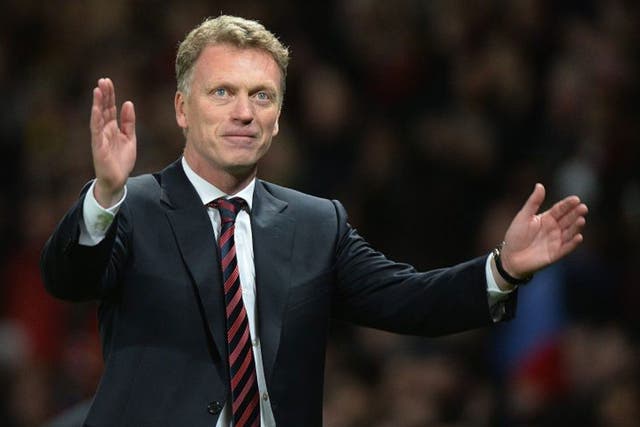 David Moyes celebrates Manchester United's 3-0 victory after the UEFA Champions League round of 16 second leg soccer match between Manchester United and Olympiacos FC at Old Trafford in Manchester