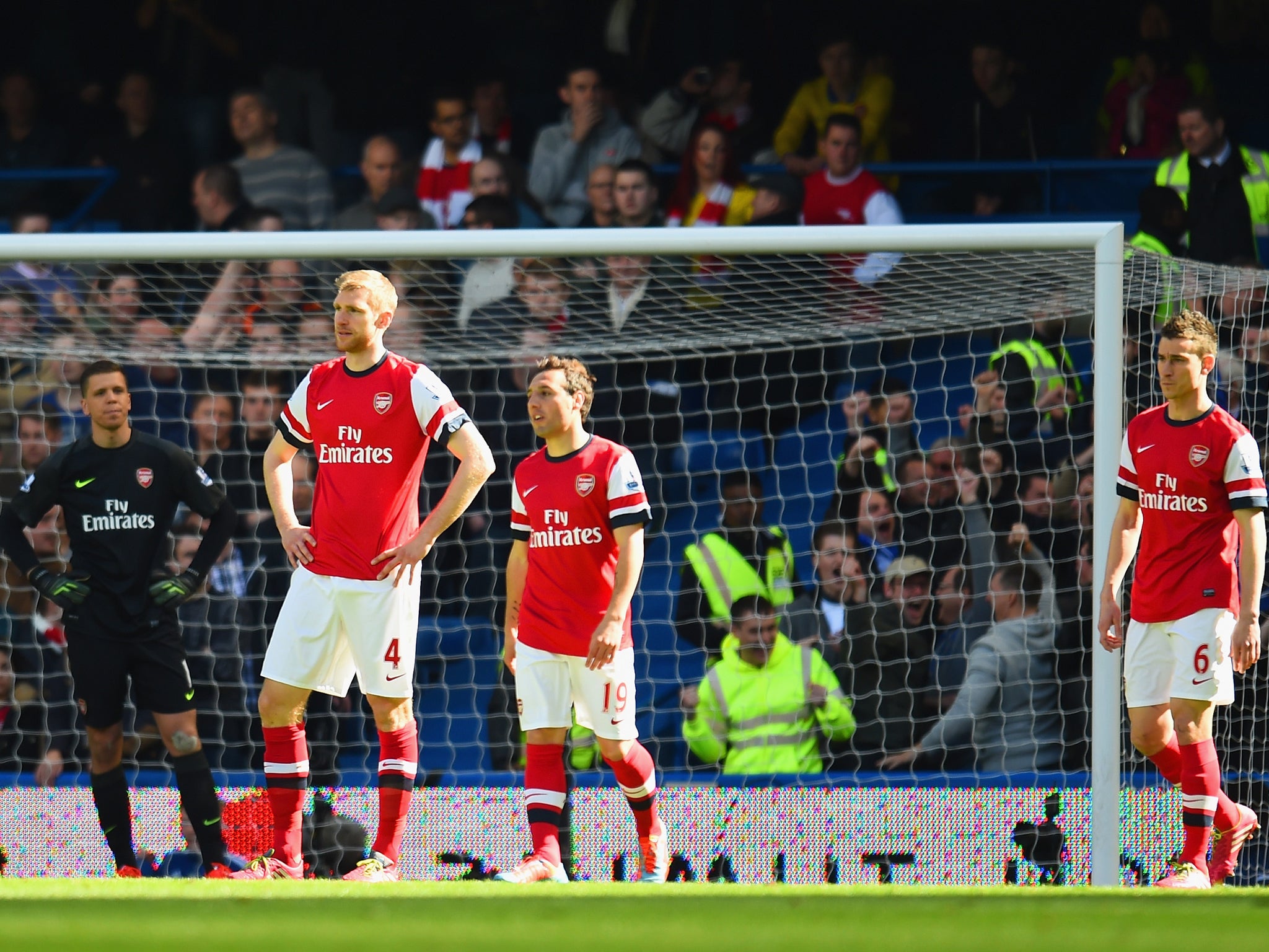 Arsenal players look on despairingly after going 2-0 down early to Chelsea