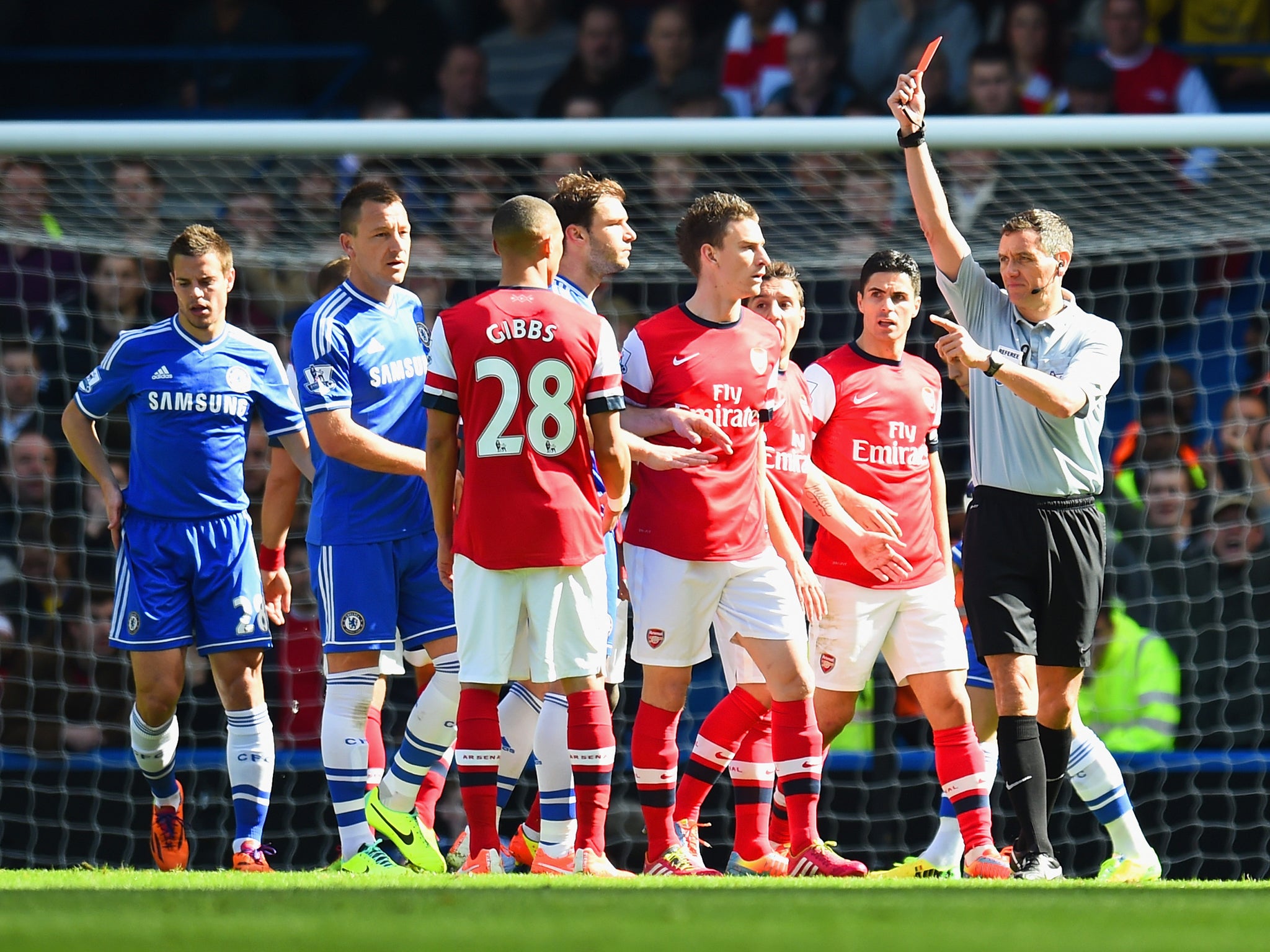 Kieran Gibbs is wrongly shown a red card by referee Andre Marriner