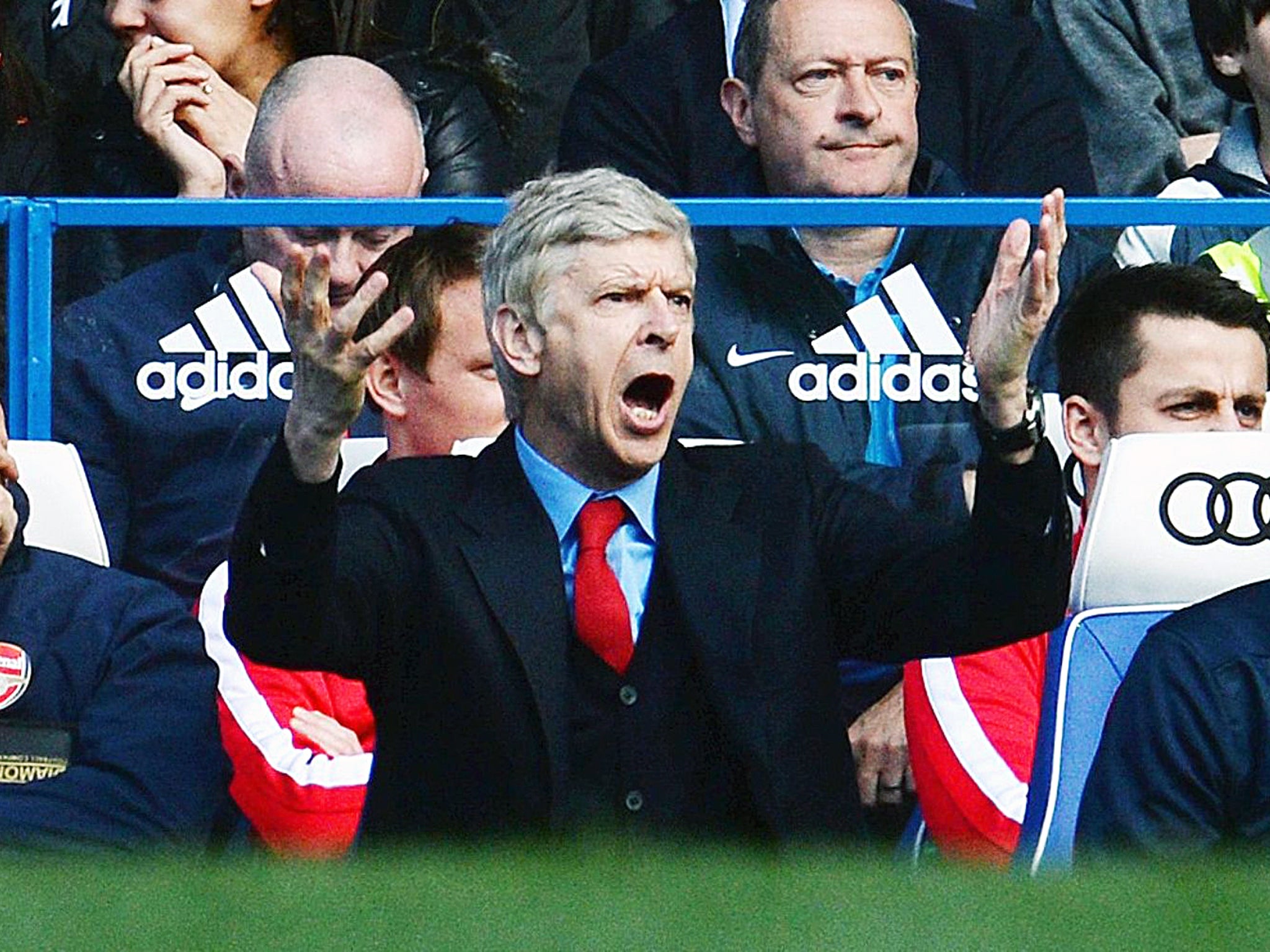 Arsene Wenger gestures from the dugout at Stamford Bridge during Arsenal's 6-0 defeat to Chelsea